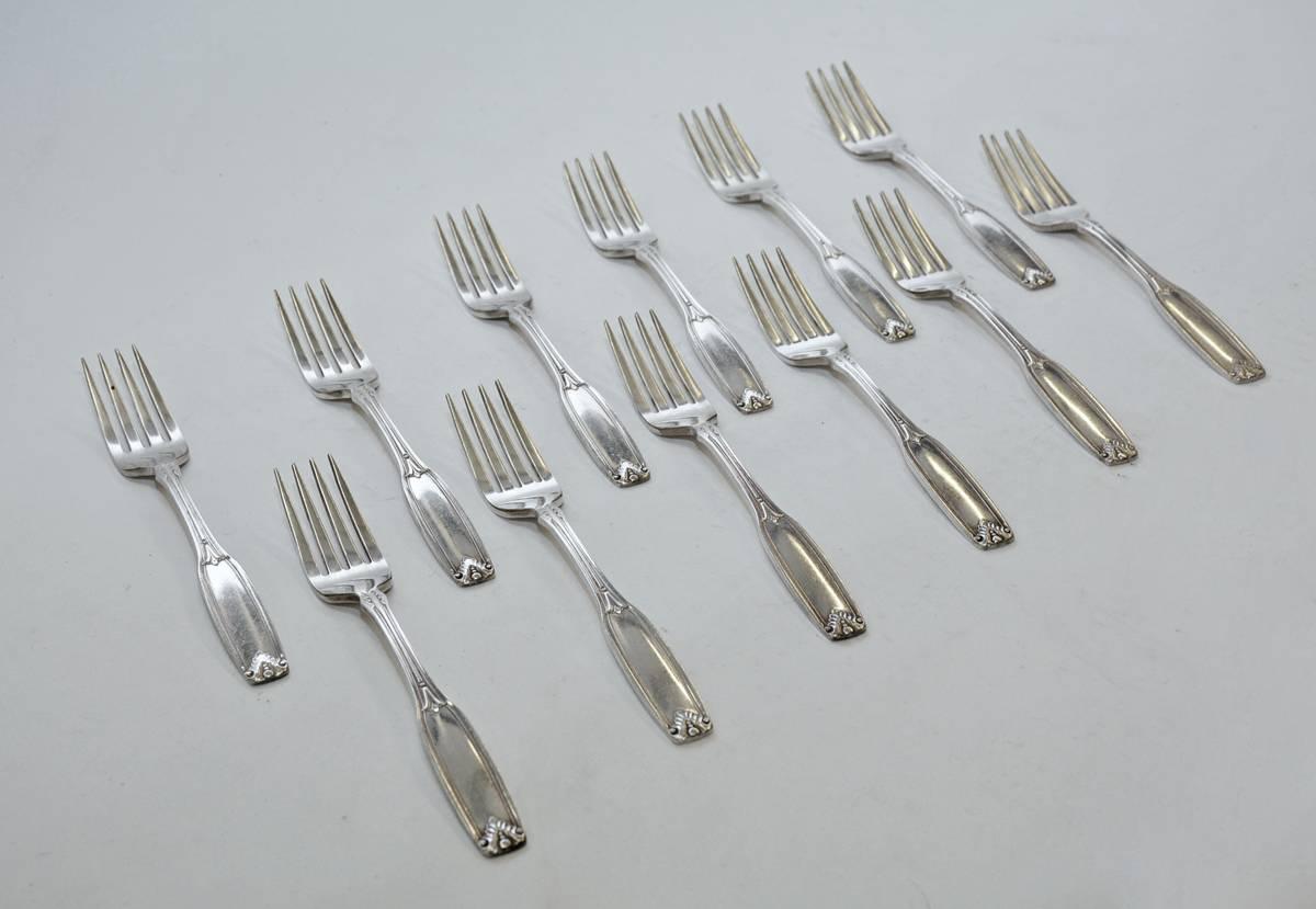 The 12 vintage hotel silver plate dinner forks are decorated with leaves and are marked 