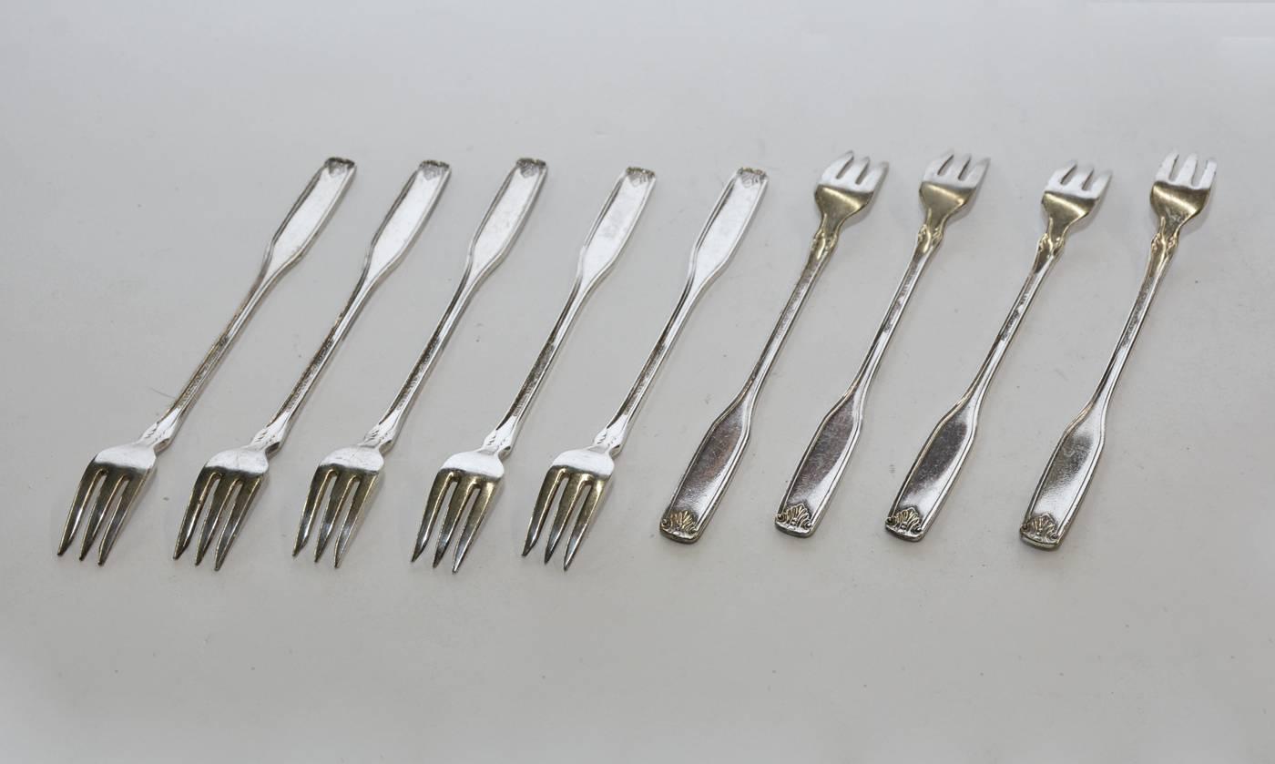 The nine vintage hotel silver plate seafood forks are decorated with leaves and are marked 