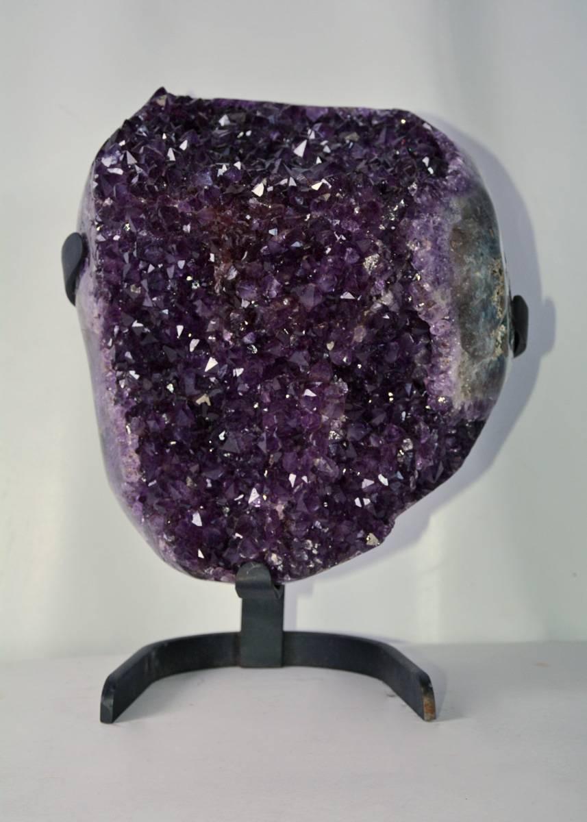 Beautiful large organic Brazilian amethyst crystal Geode sculpture on stand.  The form is somewhat heart shaped.  An amazing specimen to grace a center table or mantle.  Very impressive specimen, well presented. 

13 high without stand, 16"