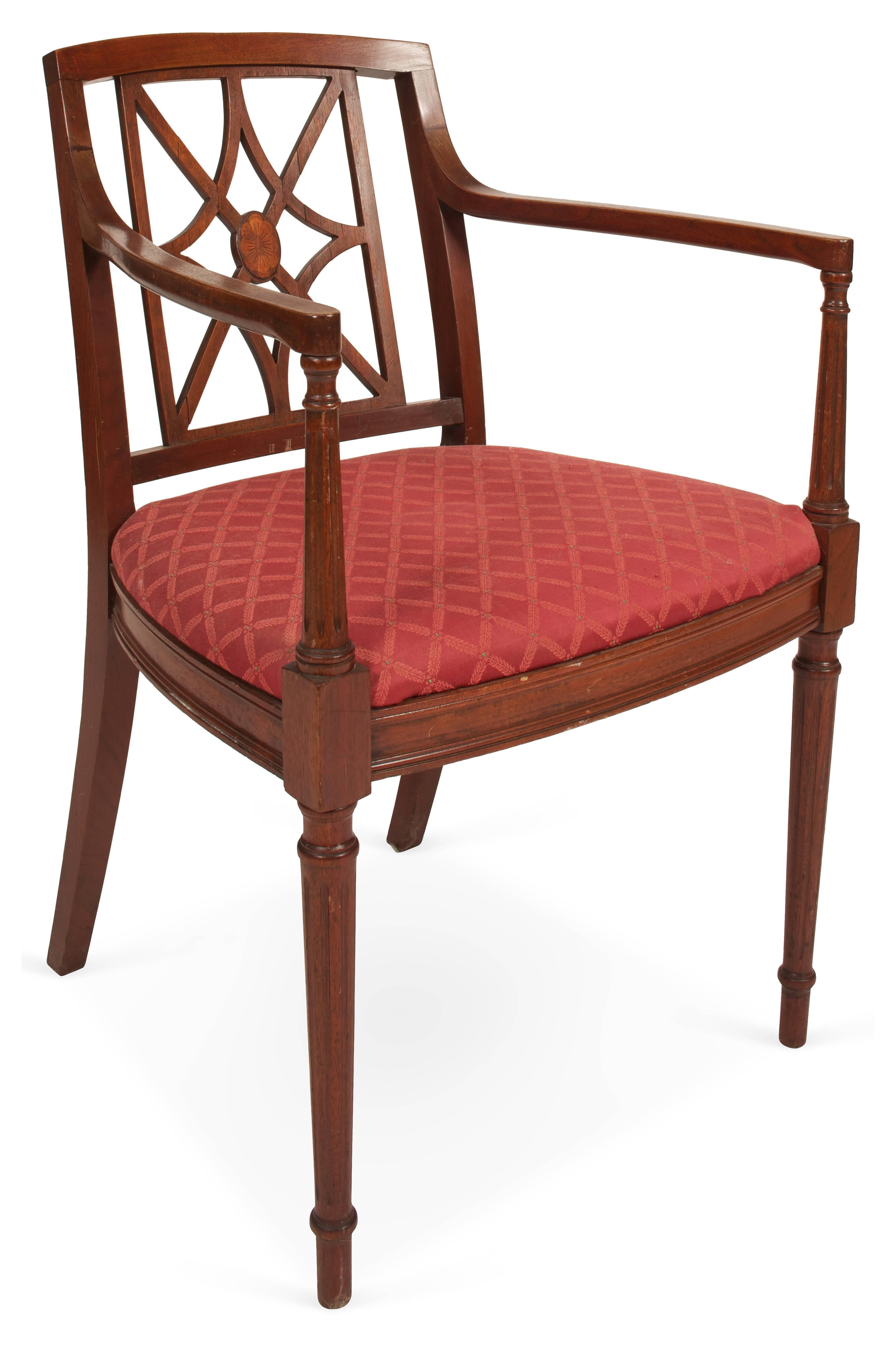 Vintage mahogany chair in the English Sheraton style has a fretwork designed back, upholstered seat, fluted front legs and arm supports.