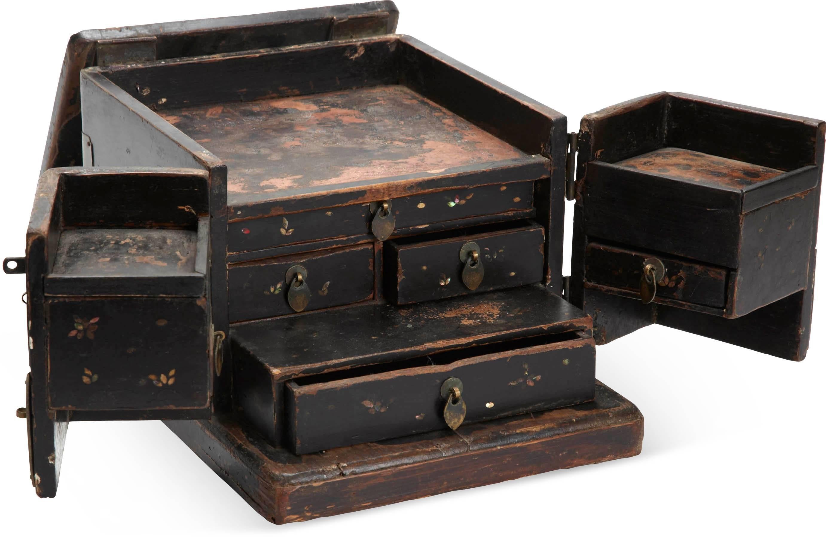 Black lacquered Chinese jewelry chest features two doors with brass mountings. The top lifts and folds away revealing drawers for storage. Wonderful aged patina.
4 x small (square), 2 x medium (rectangle) and 2 x large (square).

 