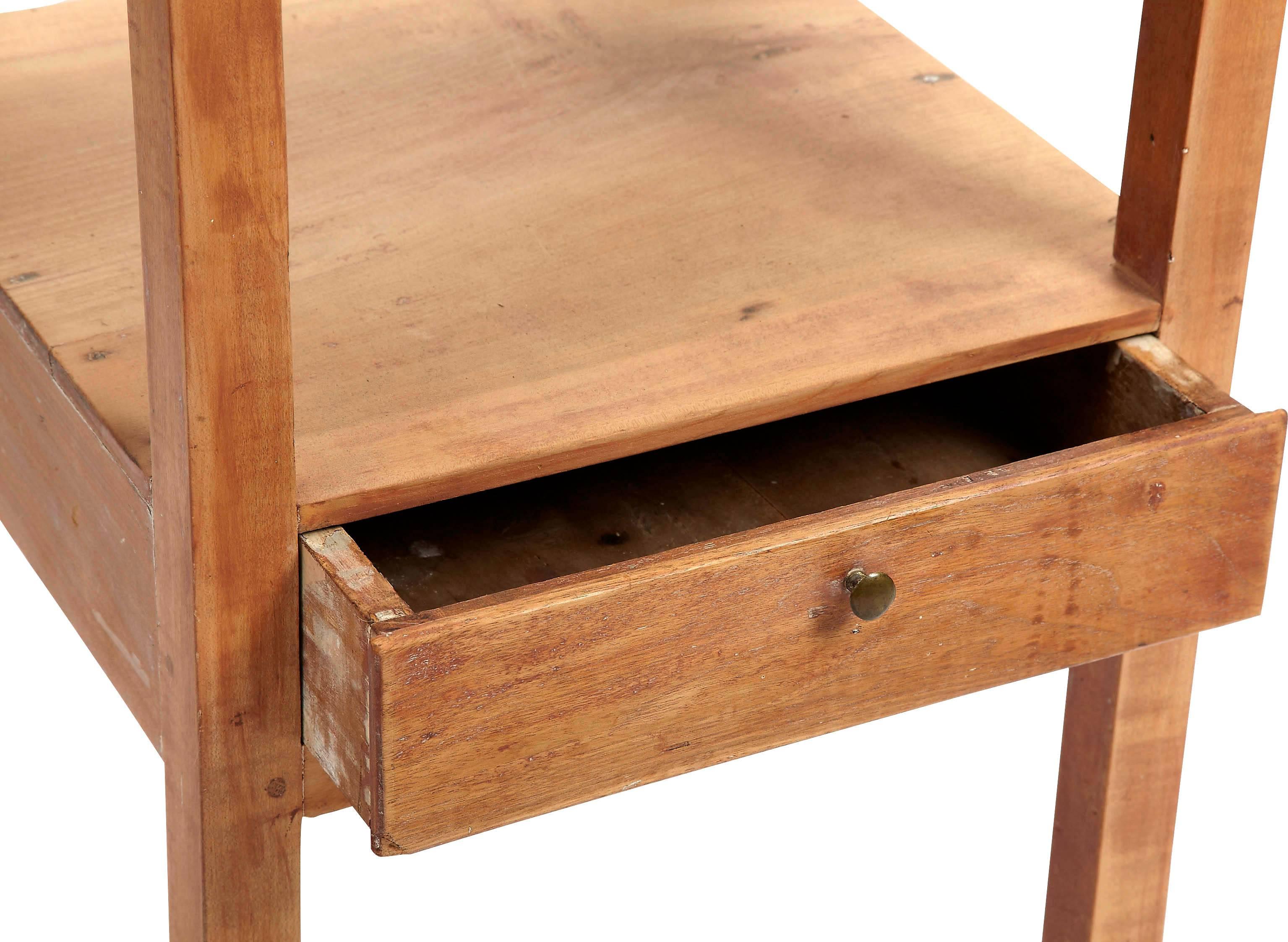 This night table or stand has a 3 sided tray like surround top and a single dovetailed drawer with a metal knob and shelf for storage and a place to put books or other items.
 