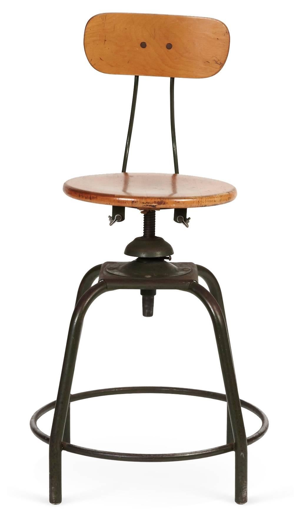 Vintage industrial style drafting stool with wood seat and back on metal frame. Seat swivels and has adjustable height mechanism. 

Measure: Seat diameter 15