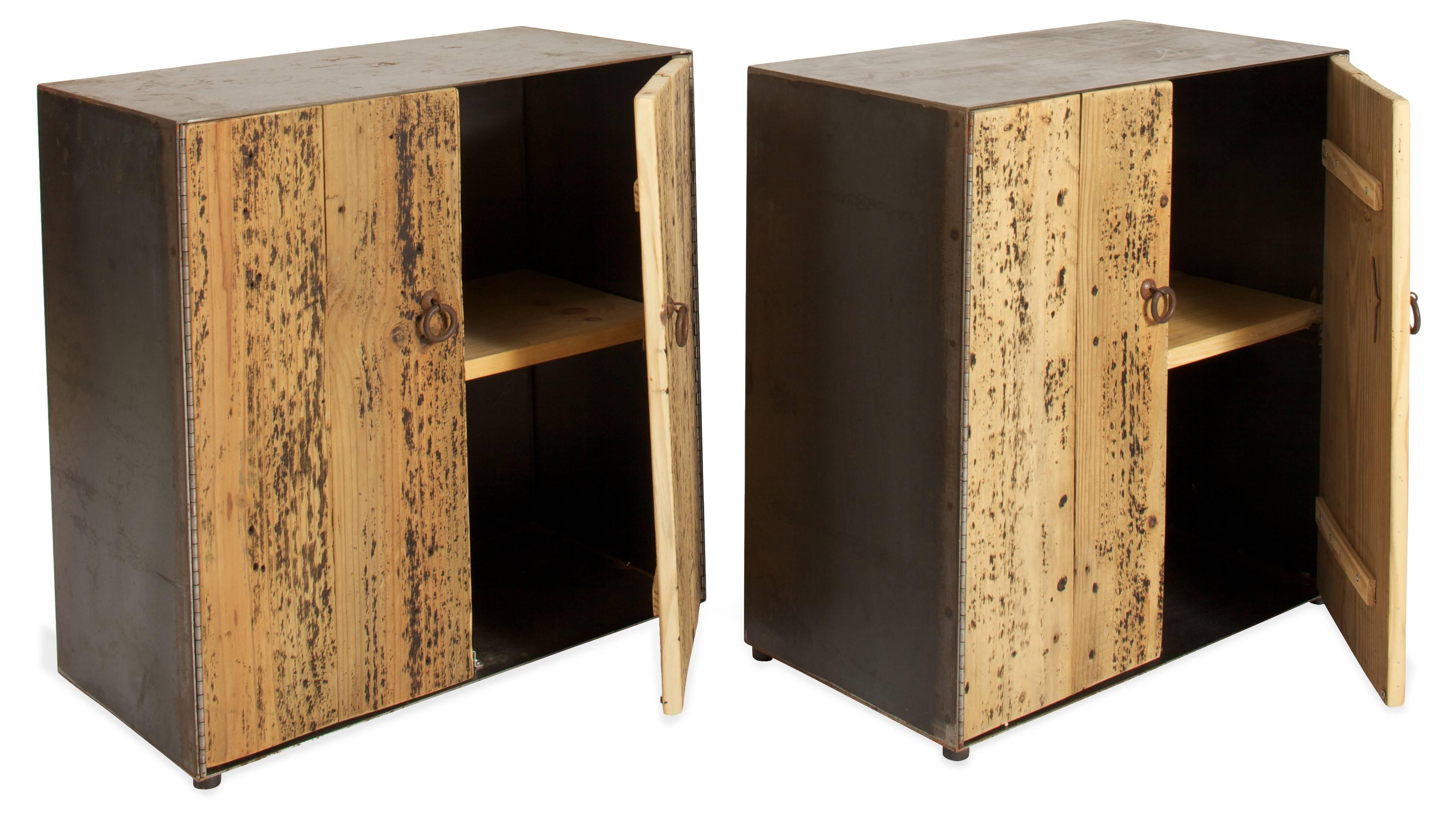 Cabinets composed of steel outer casings and rustic pine plank double doors and single pine shelves inside. Paint residue on doors give a speckled effect - steel ring pulls. Can be used as nightstands or side tables. Sold singly. We can add