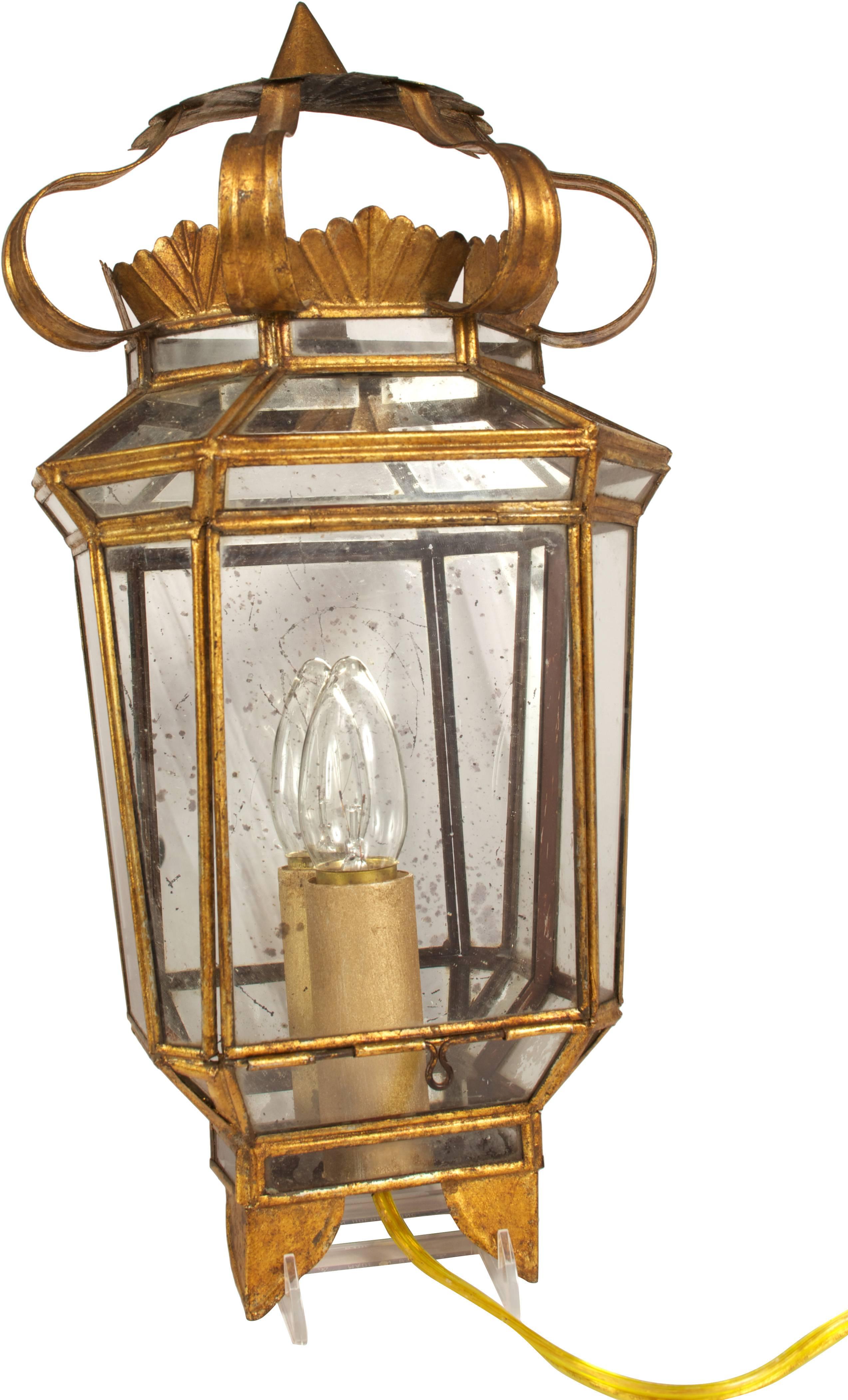 Venetian in style, the gold gilt metal wall light has glass panels, gilt detailing and mirrored backing. Front panel is hinged for opening to change bulbs. Great for hallway lighting, bathroom lighting or entry way light wall sconce. Electrified for