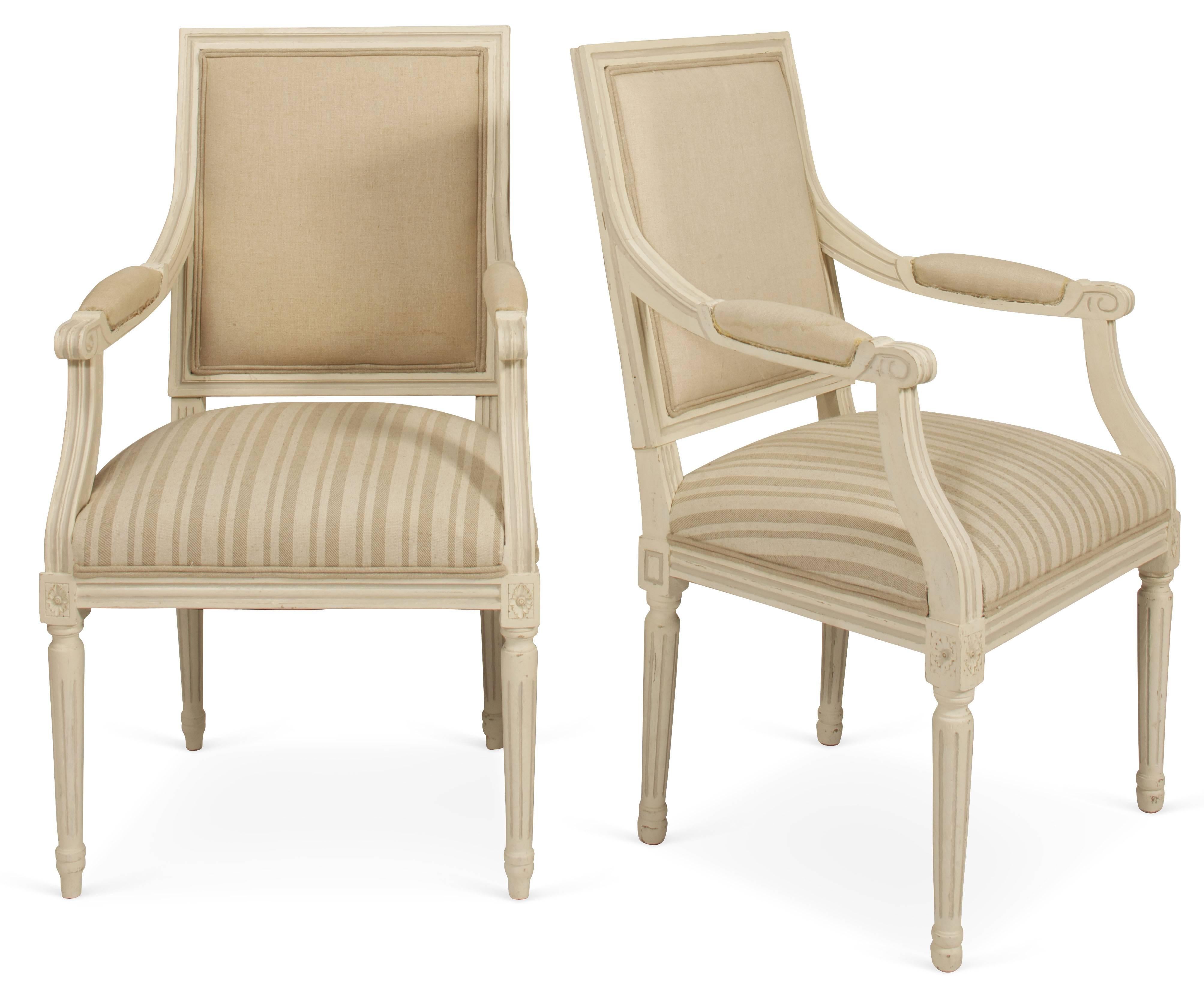 Upholstered in beige linen on the backs and arms and in striped linen on the seats, these chairs have frames painted in two shades of French cream. The chairs are perfect for dining room chairs, office desk chairs or occasional chairs. Lends