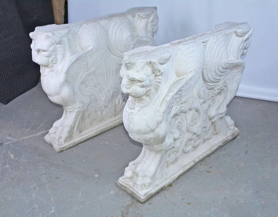 Two grand and very impressive cast concrete neoclassical style pedestal dining table bases with finely detailed winged griffins. Will support a large stone, marble or glass table top. Can be used indoors or outdoors. Will make a very grand base for