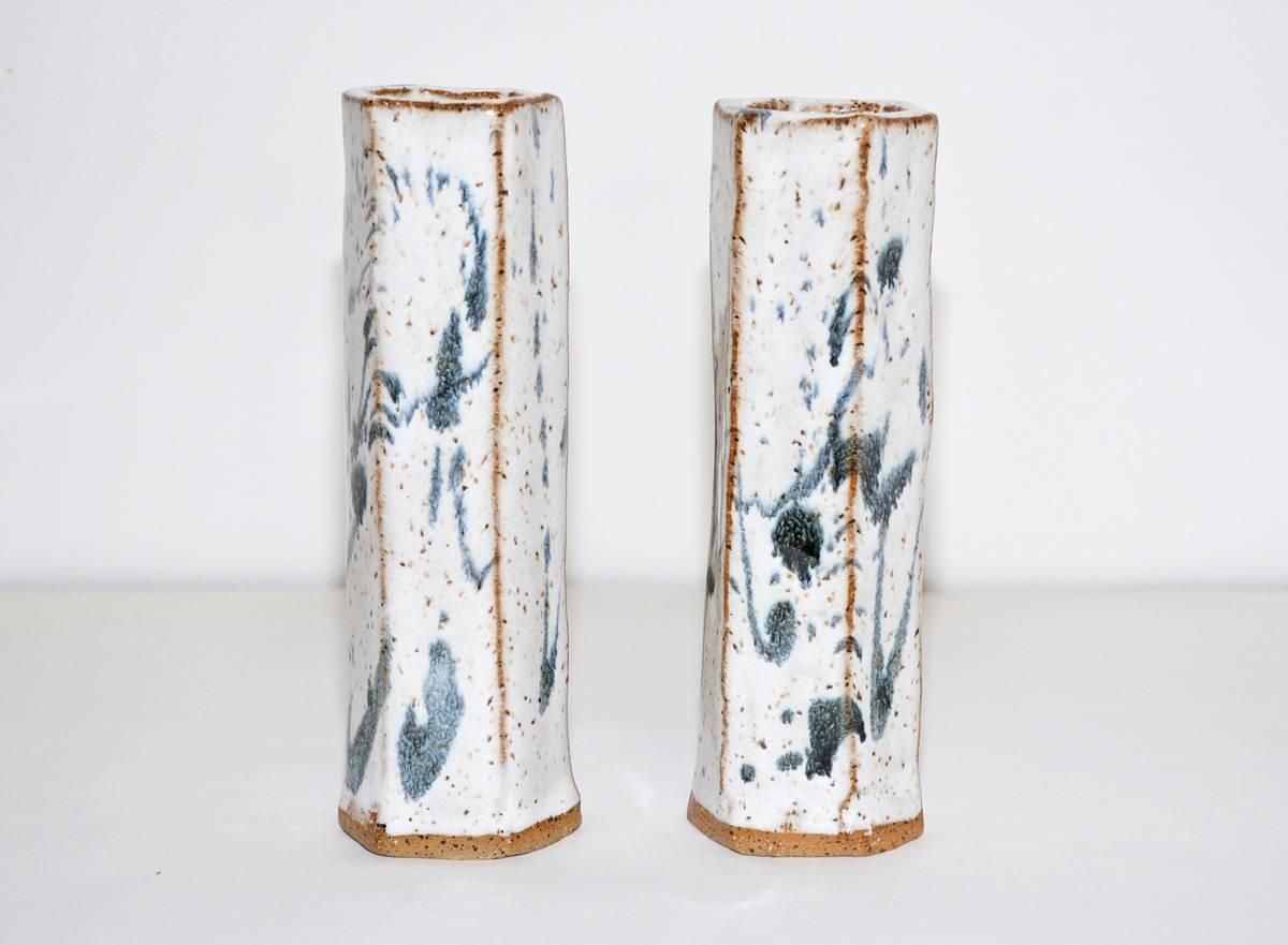 Pair of classic low-fire stoneware flower vases with white glaze and blue decoration.