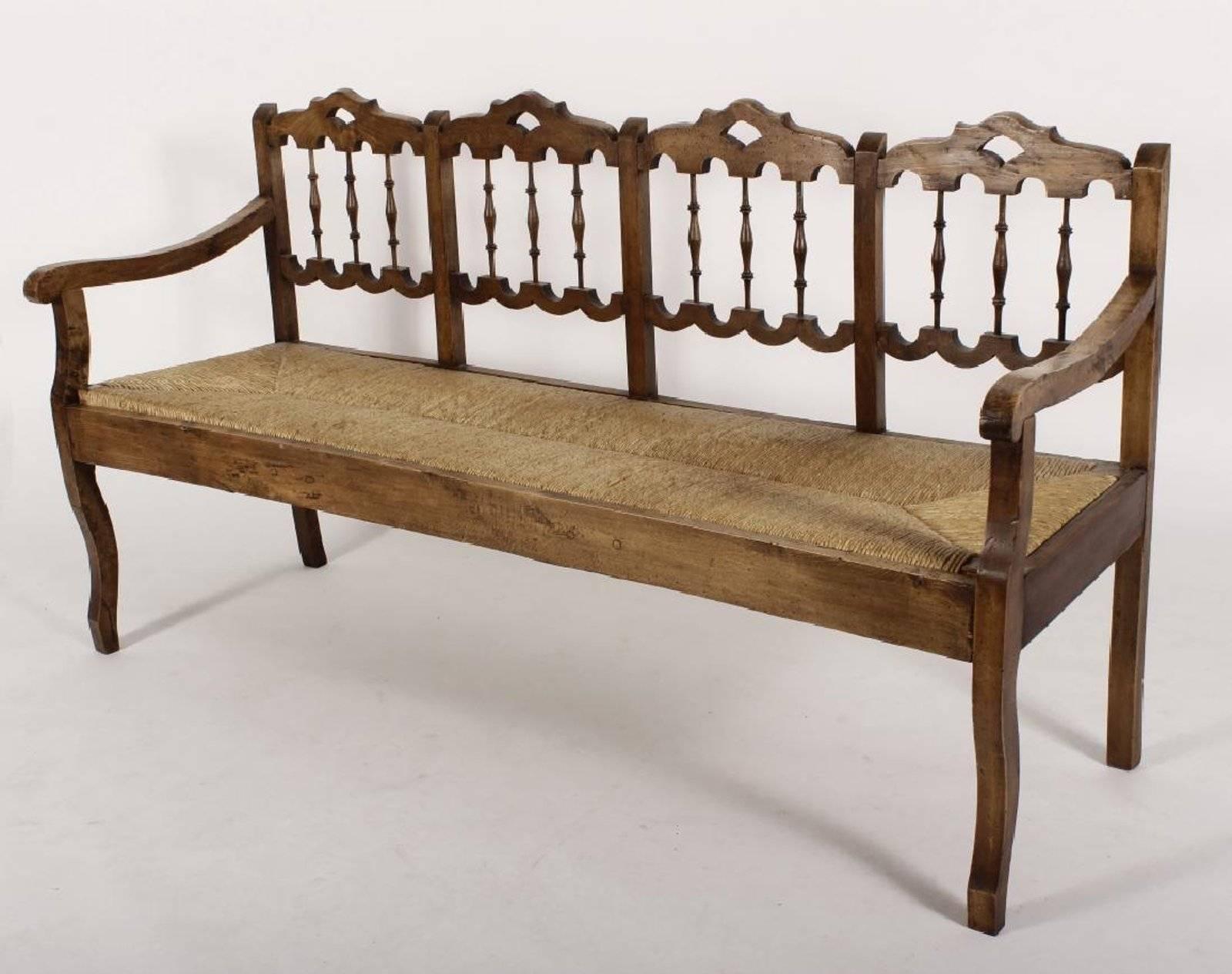 Anglo-Indian style turned wood, rush seat, spindle back bench.
Measure: Arm height 27