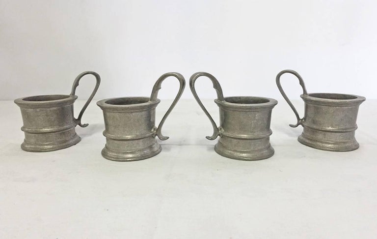The four vintage pewter holders do not have bottoms and are made to hold glass tumblers. Great as decorative objects on kitchen shelves or dining room.