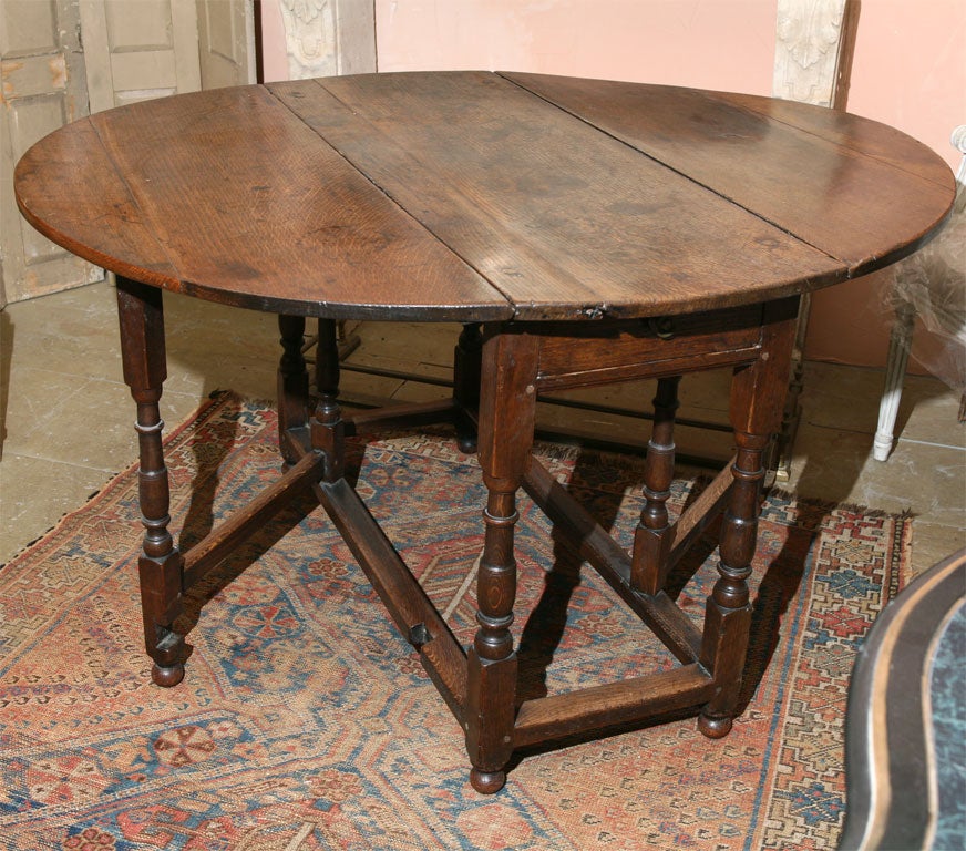Fine example of 19th century English gate-leg or drop-leaf table. Beautiful patina. Perfect for kitchen, dining room, small apartment, entry foyer table or sofa table.
The table with the leaves dropped measures 44