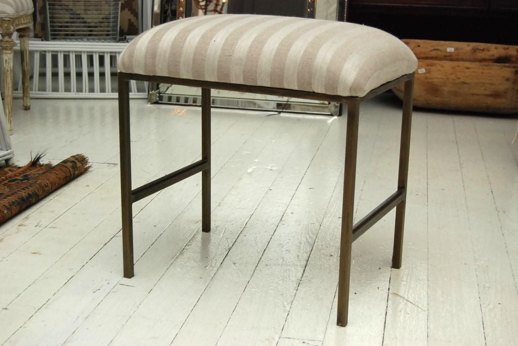 Metal bench with upholstered seat in your fabric or we can provide generic linen fabric. Perfect as vanity stool or entry hallway bench. We can size it to your needs. Different finishes available.