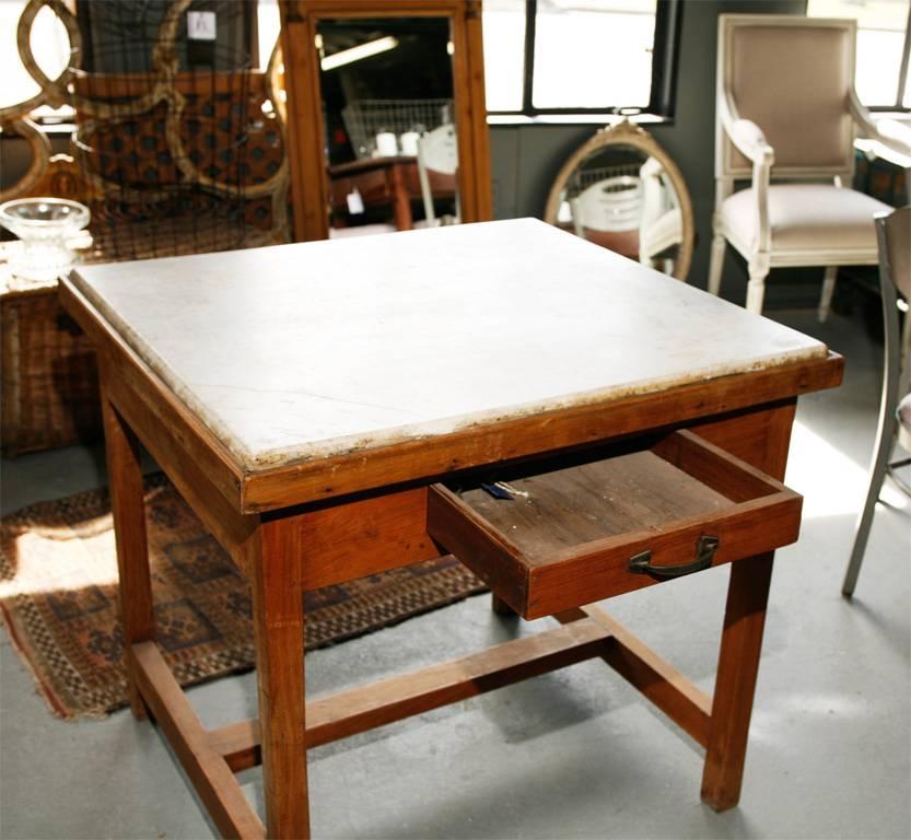 French kitchen worktable with marble top. Perfect in a kitchen. Marble has wonderful distressed quality.

Center island, butcher block and baker's table.