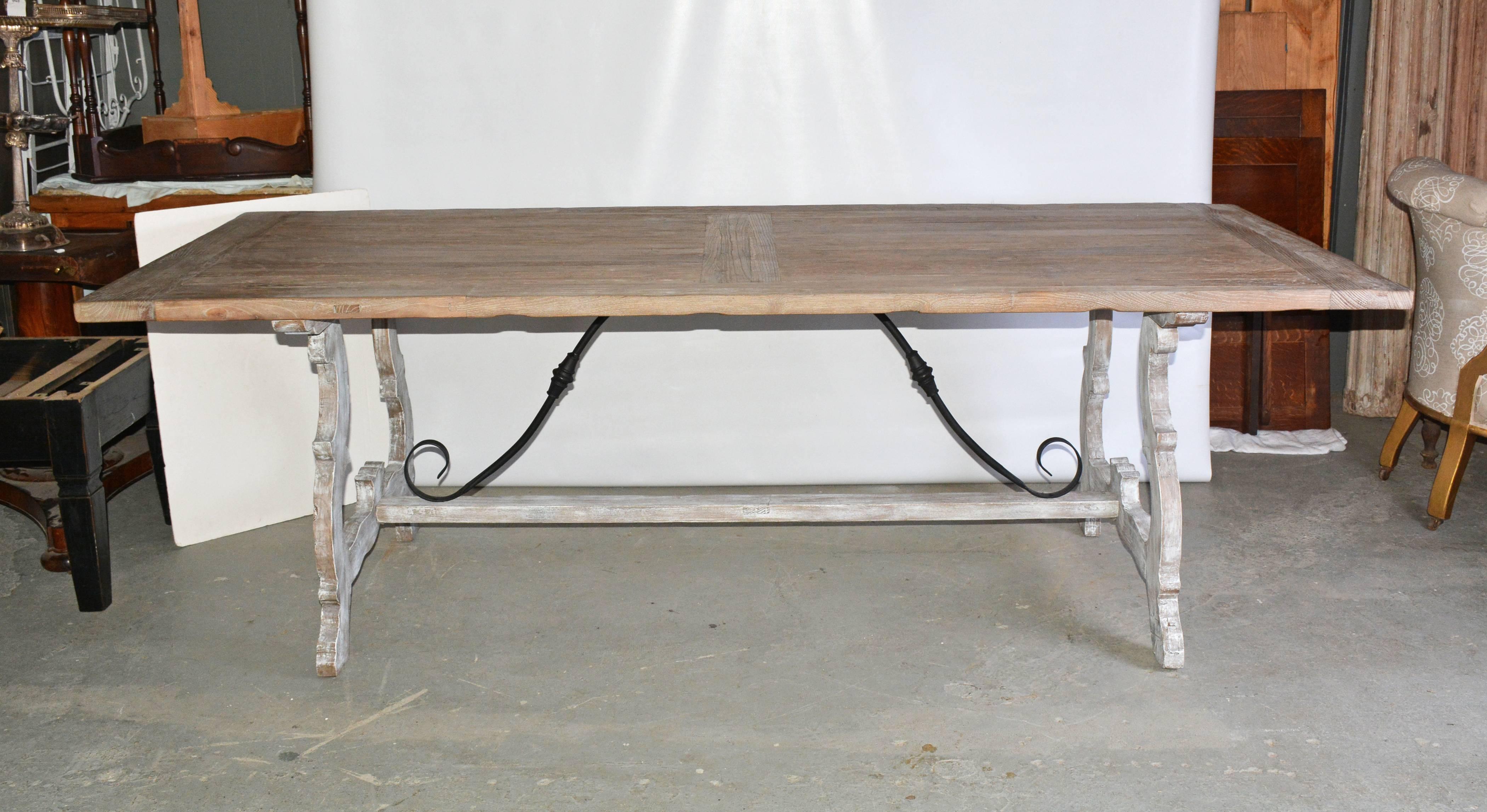 Can be Mediterranean Tuscan Italian or Spanish Renaissance style refectory dining table. Combines a elm wood top with breadboard ends and a Baroque-style oak and wrought iron base. Seats up to ten diners.