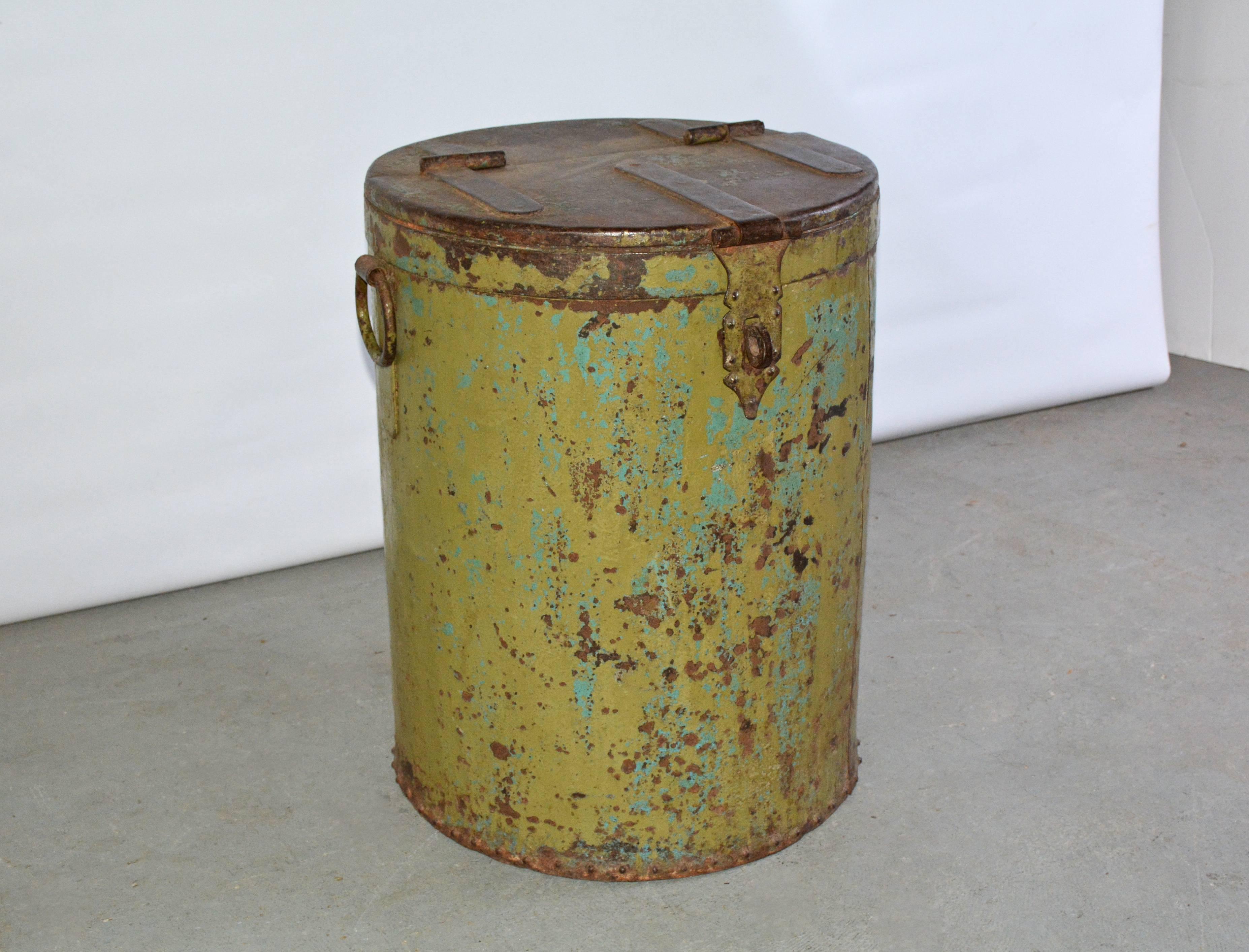 Large rustic industrial barrel or drum with hinged lid.
Possibly used to store grain or dry goods at one time. Can be used for side table, end table, pedestal base, wood or toy storage bin. The barrel has green paint rustic worn metal patine color.