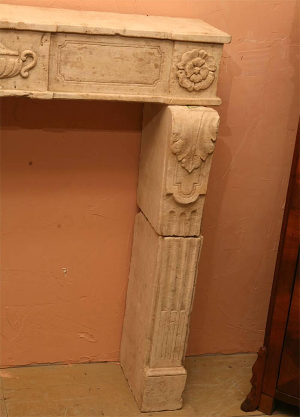 Unusual classical Louis XVI hand-carved limestone fireplace mantel, surround chimneypiece with carved urn and rosettes at the top of pilasters, tapered fluted jam supports that will make your house that much more special. 

Opening is 35.5 x 35.5.