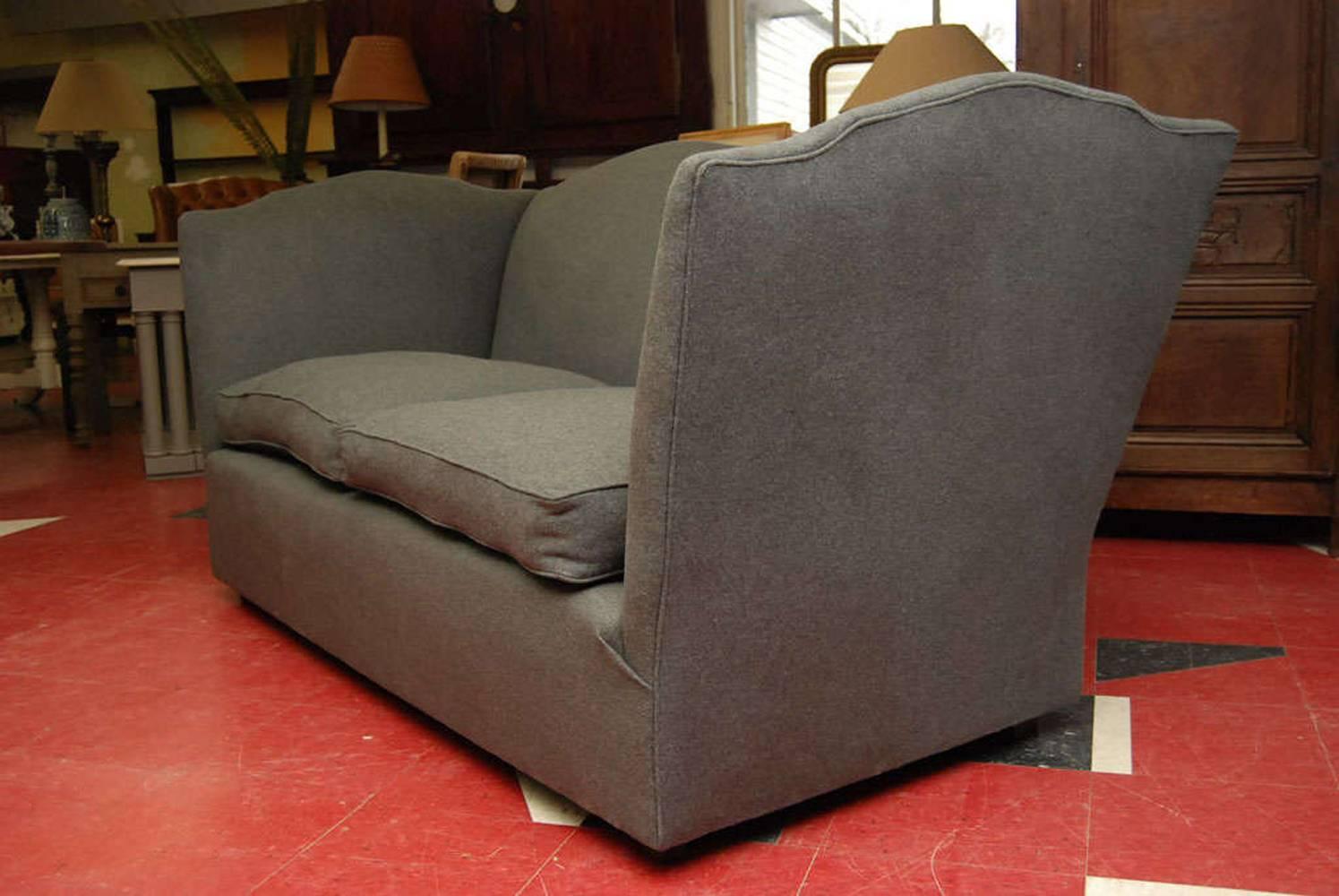 Italian camelback sofa upholstered in charcoal grey wool flannel. Very comfortable with high back and sides.