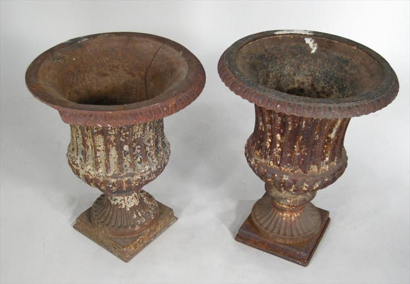 2 similar cast style garden urns with gadrooned edge, fluted body on pedestal base with alligatored remnants of old paint.



Keyword: planters.