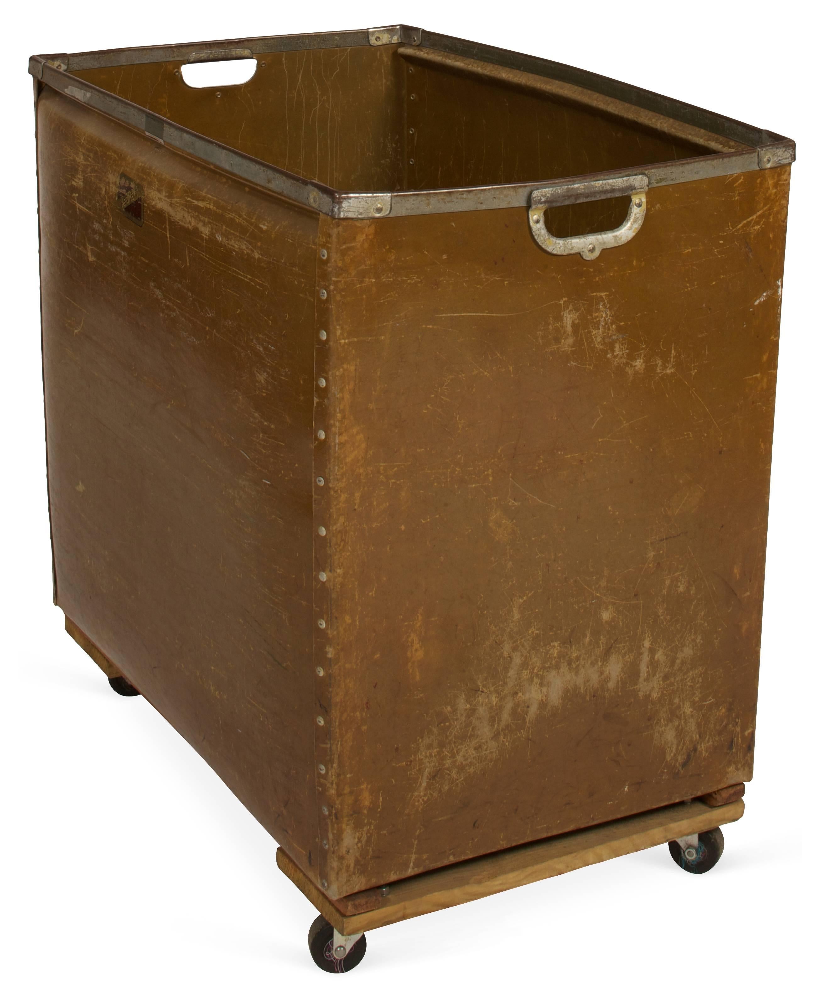 The large industrial cart is made by Kennett with two-hole handles, iron braces and metal studs on casters. These were used for moving or sorting mail. Can be wonderful as laundry basket, toy chest or storage cart. Made of thick wax coated