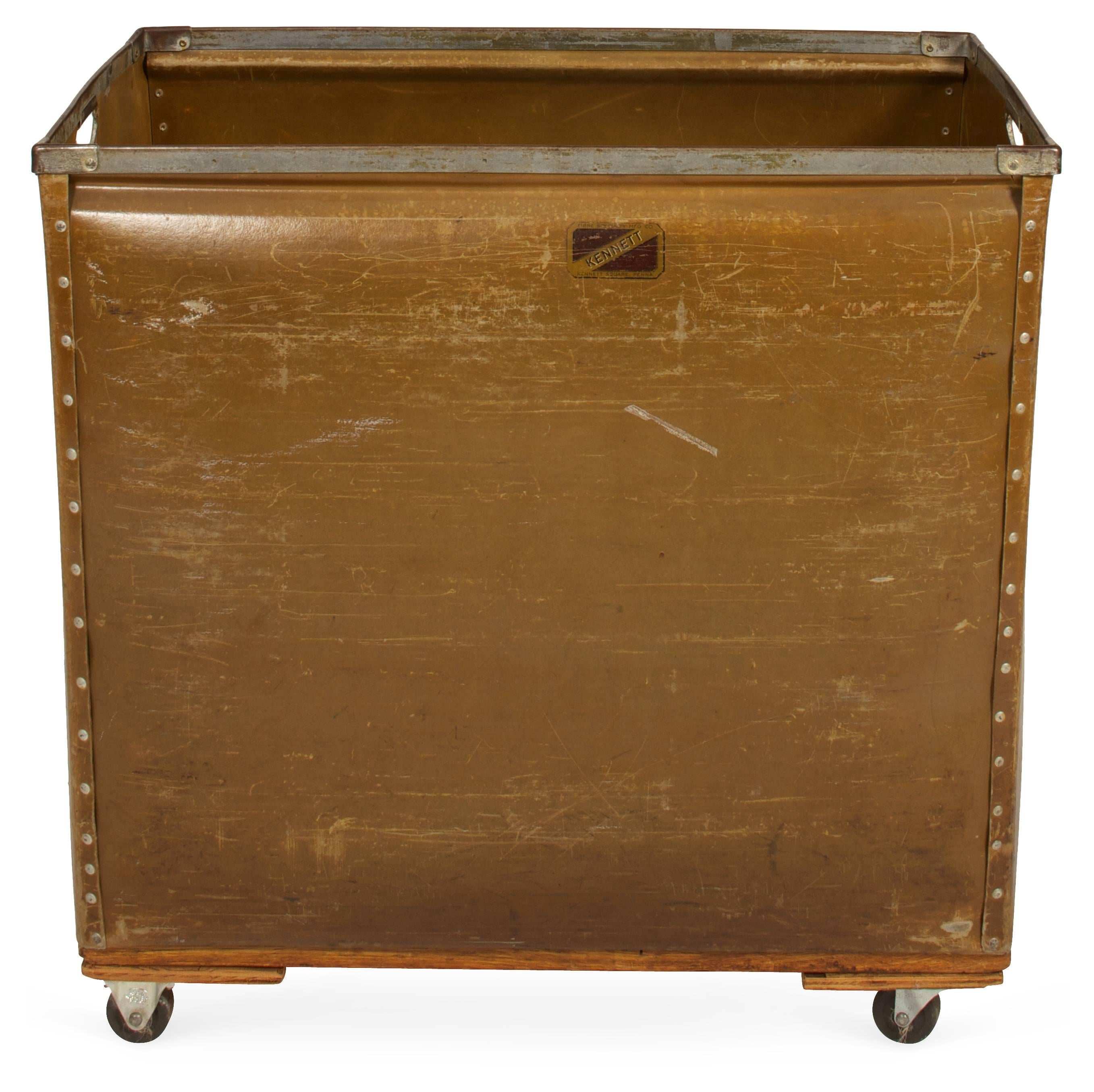 Made by Kennett, this Industrial style mail cart has two-hole handles with iron braces and metal studs. These were used for sorting mail. Can be used for laundry or children's toys and just any objects hanging around for storage or display.
The