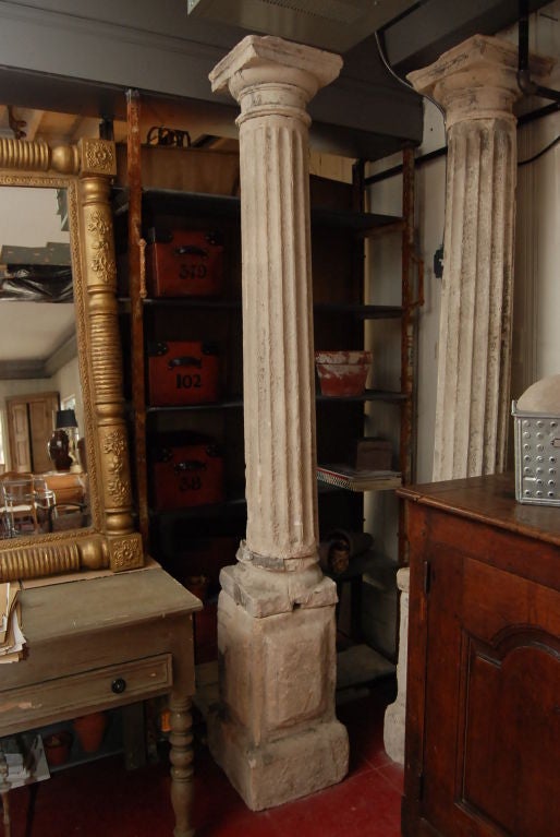 These fluted columns are from the Loire Valley and are in the Tuscan style, a Roman order and one of the five classical orders. The columns sit on panelled plinths. Each column is composed of four separated parts: capital, fluted shaft, column base