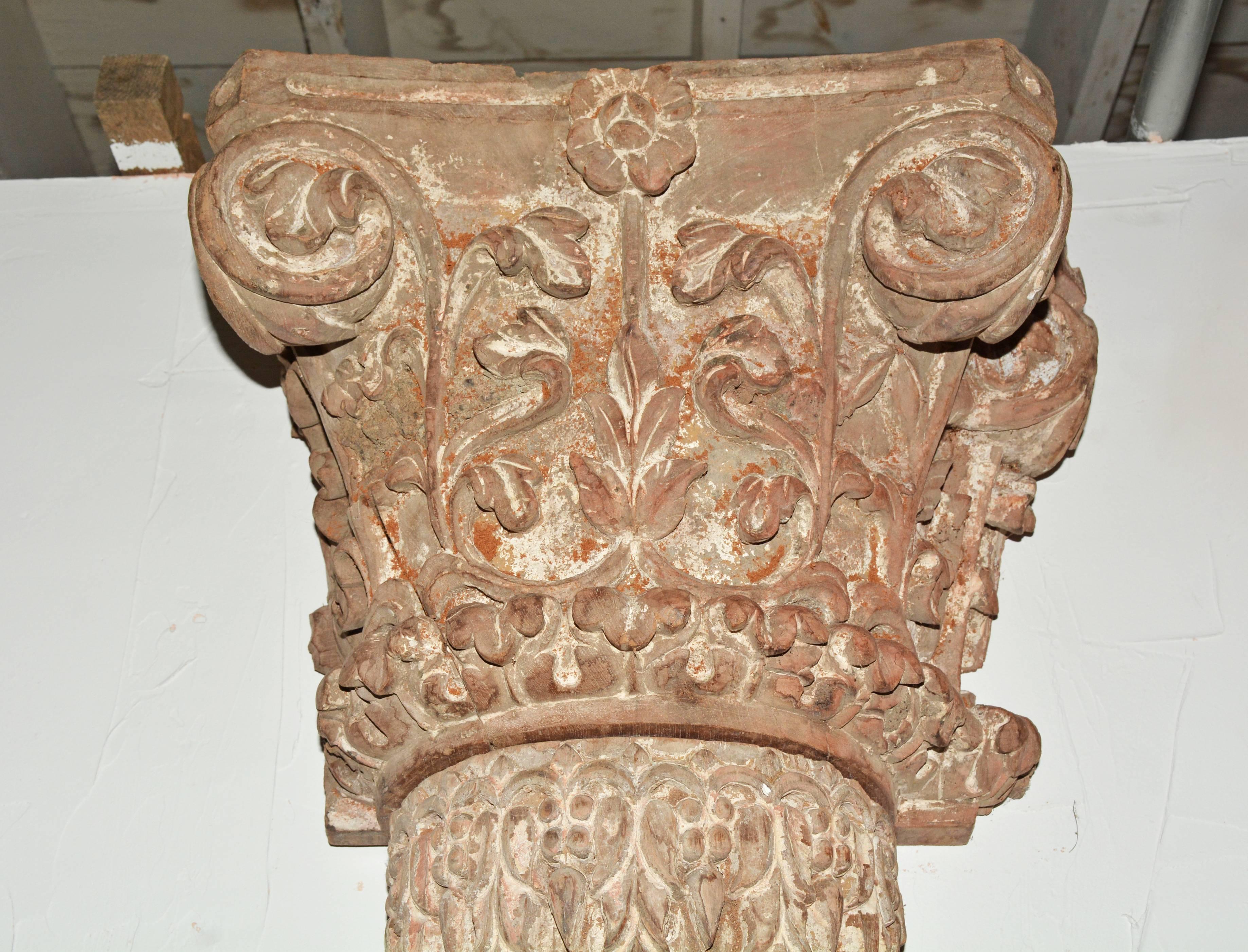 The pair of antique pilasters have semicircular fluted shafts, decorative bases and flat backs, all hand-carved. Also carved by hand with leaves and vines are the matching Corinthian capitals with flat backs, the whole unique scheme may be attached