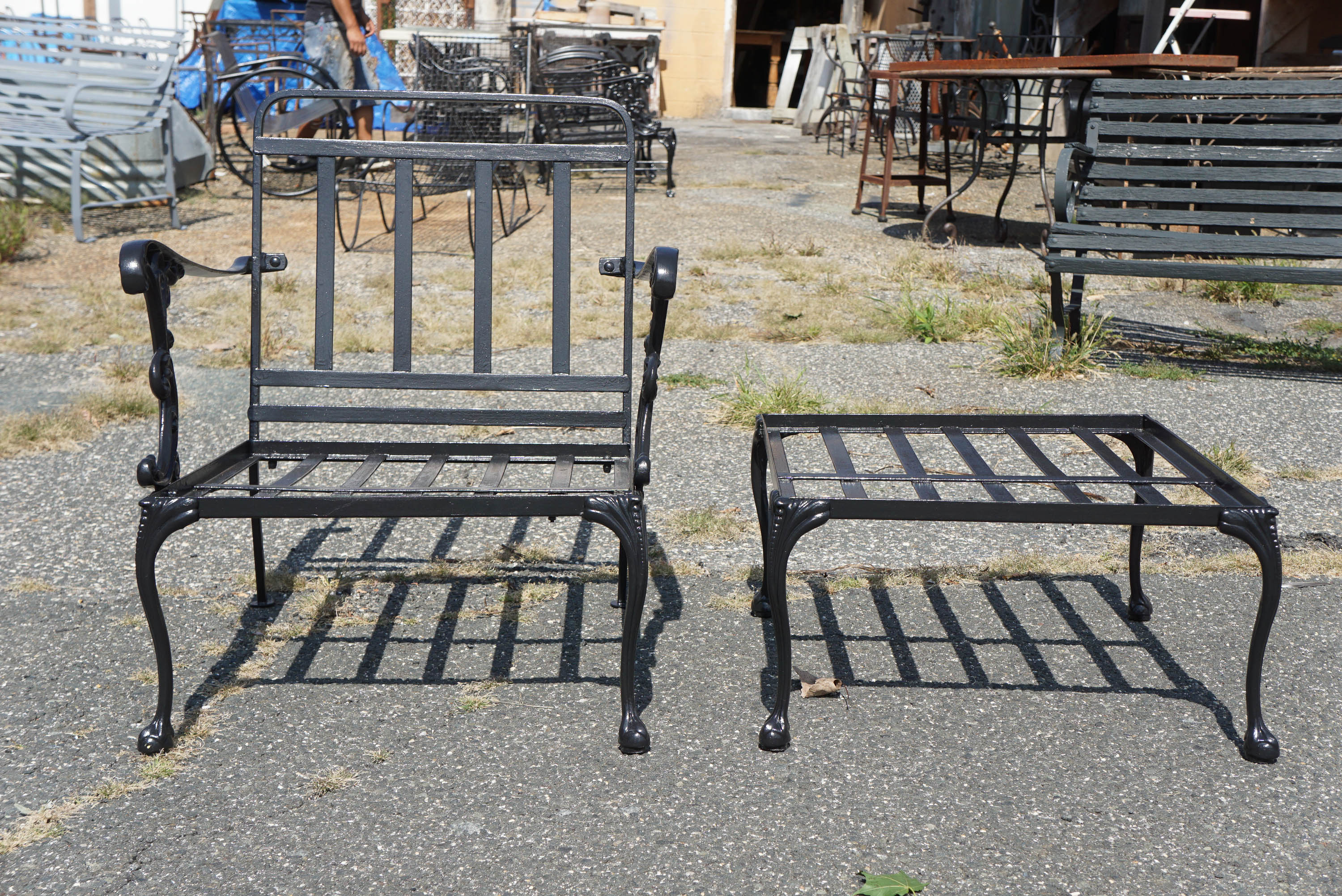 This extra wide outdoor metal garden lounge chair has arms with decorative Rococo supports. The chair and square foot stool or ottoman have cabriole legs with ball-in-claw feet. Newly sandblasted and primed in black.

Measures: Arm height 24