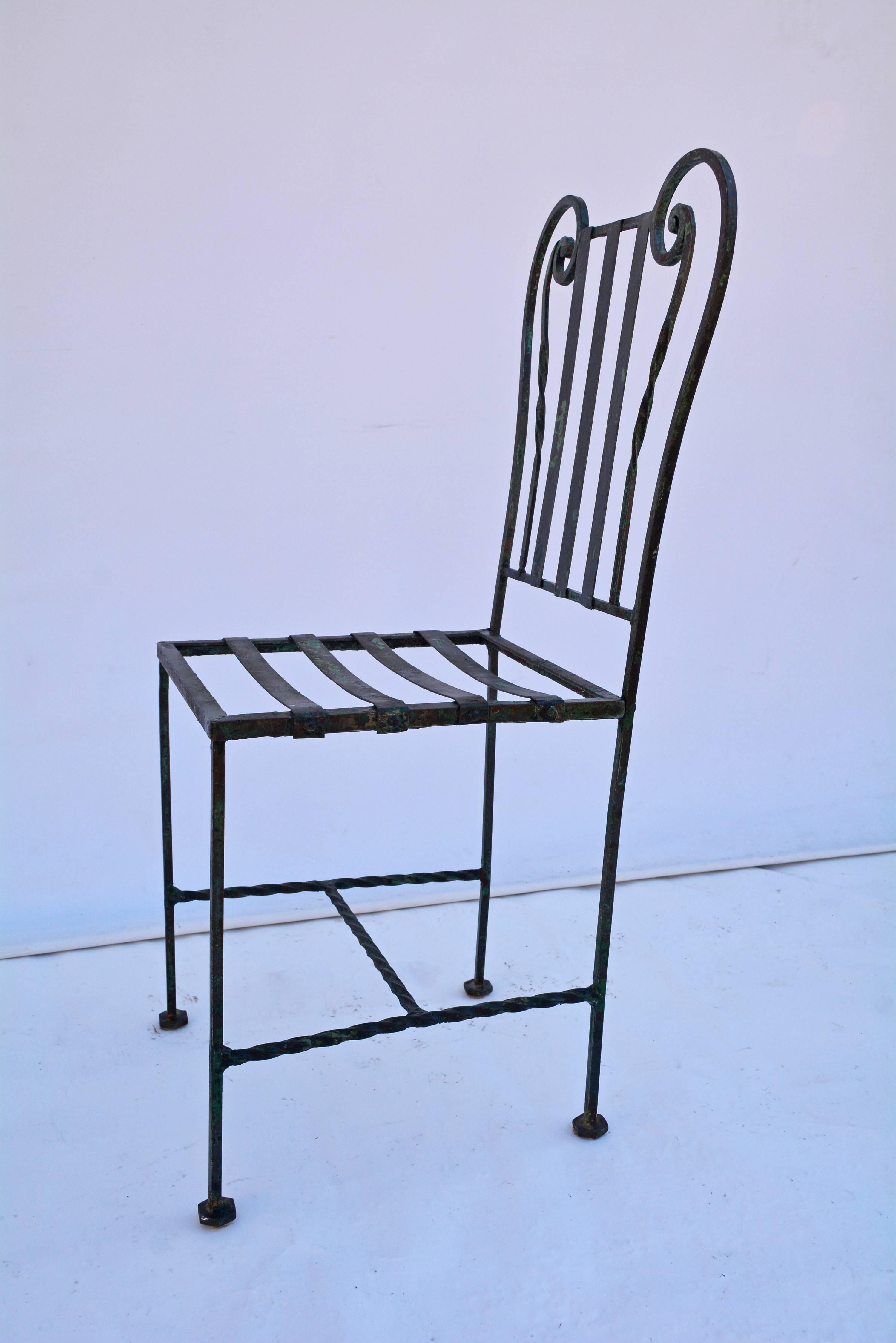 Highly decorative metal indoor or outdoor side chair has a Lyre-style back and seat slats to hold a cushion. Stretchers are spiral bars. Can be used as desk chair, vanity chair, or accent chair.