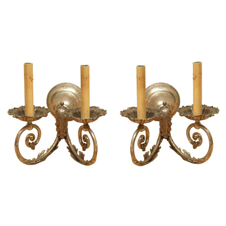 Pair of silver gilt two-arm wall sconces with leaf motif. Height includes candle shaft. Sconce height is 5.5
