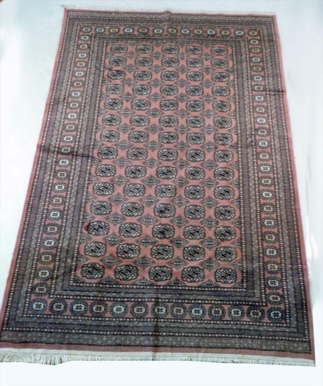 Tabriz style carpet in tones of mauve, black and Ivory.
