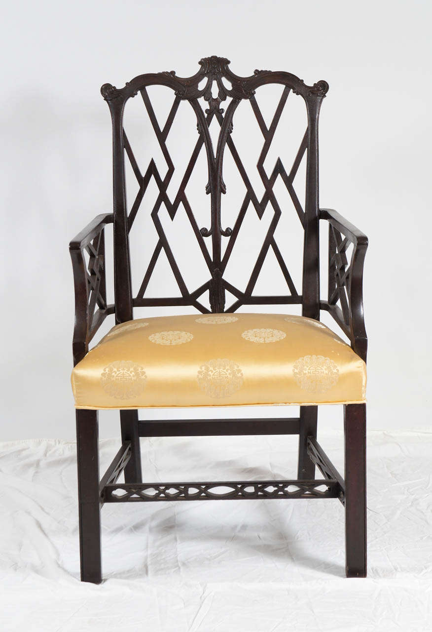 Chinese Chippendale-style armchair with elegant fretwork on back, arms and stretchers - and lots of pizzazz. Black lacquer wood and gold patterned satin upholstered seat. For extra seating in the living room or perfect as a desk chair.

Measures: