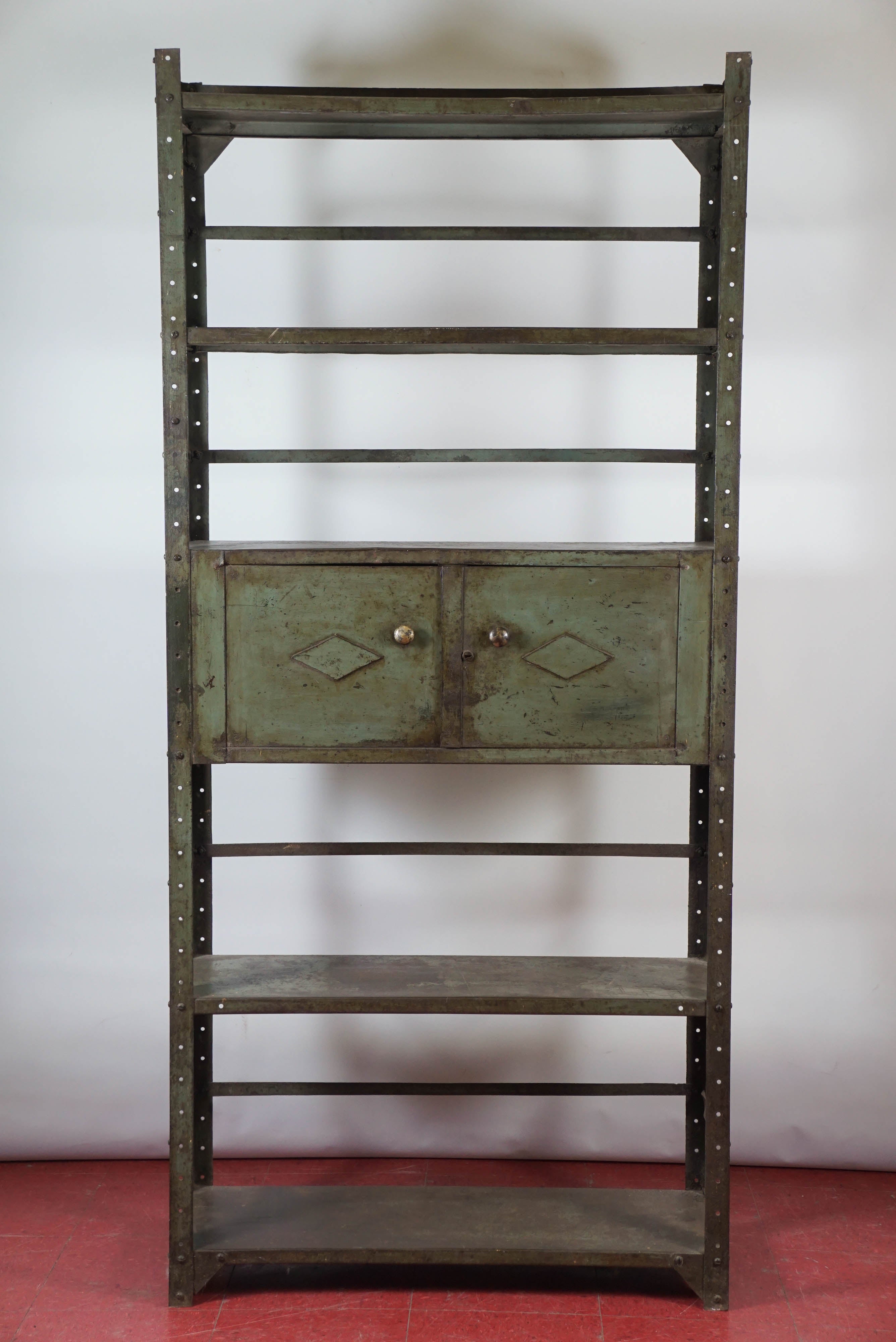 This industrial bookcase cabinet and or shelving unit consists of four to five shelves depending on height of ceiling where it will be placed plus center cabinet with double doors (magnetic closing) and braces across the back and sides compose this
