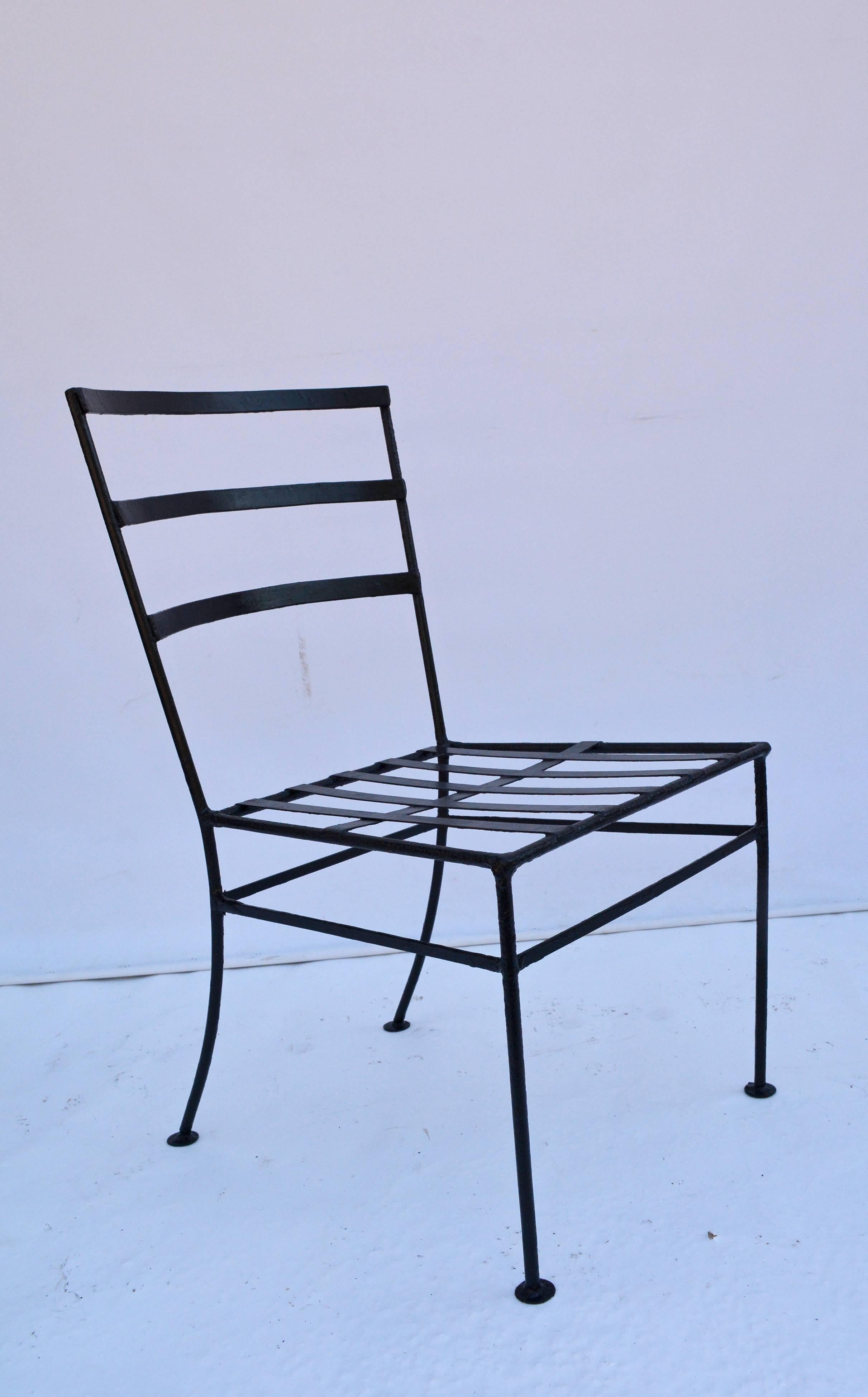 Vintage metal garden lounge or dining chairs are made of black wrought iron. One chair has arms and the other is armless. The cross-hatch seats are ready for the cushions of your choice.

Measures: Armchair: seat 16.25