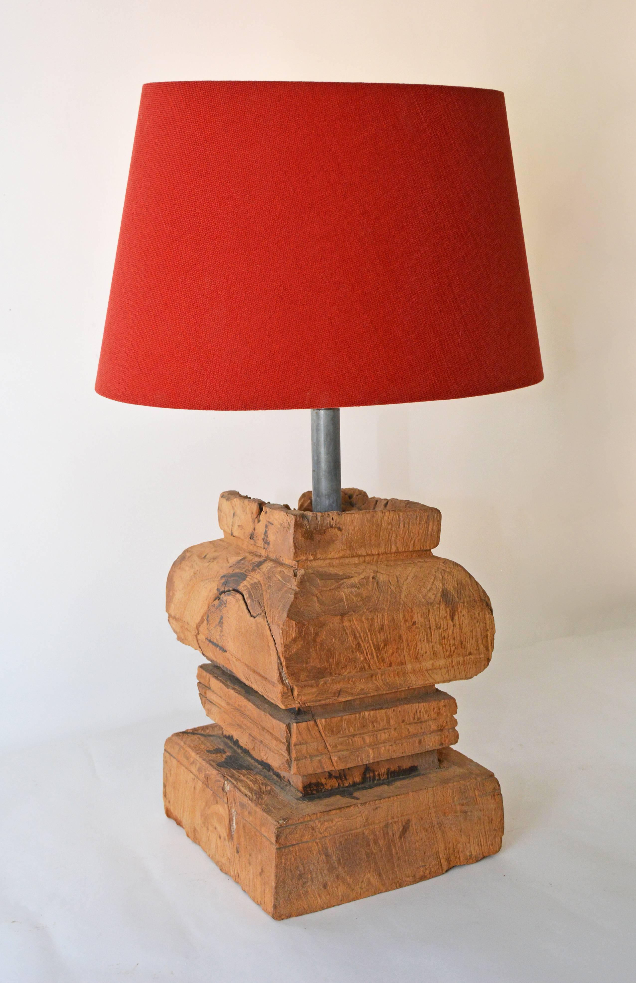 The rustic organic lamp is composed of an antique Chinese carved wood base made from an architectural element and a red Belgium linen oval shade. Lamp and shade can be sold separately. Lamp $1200/shade $600.

Measures: Shade 10.50