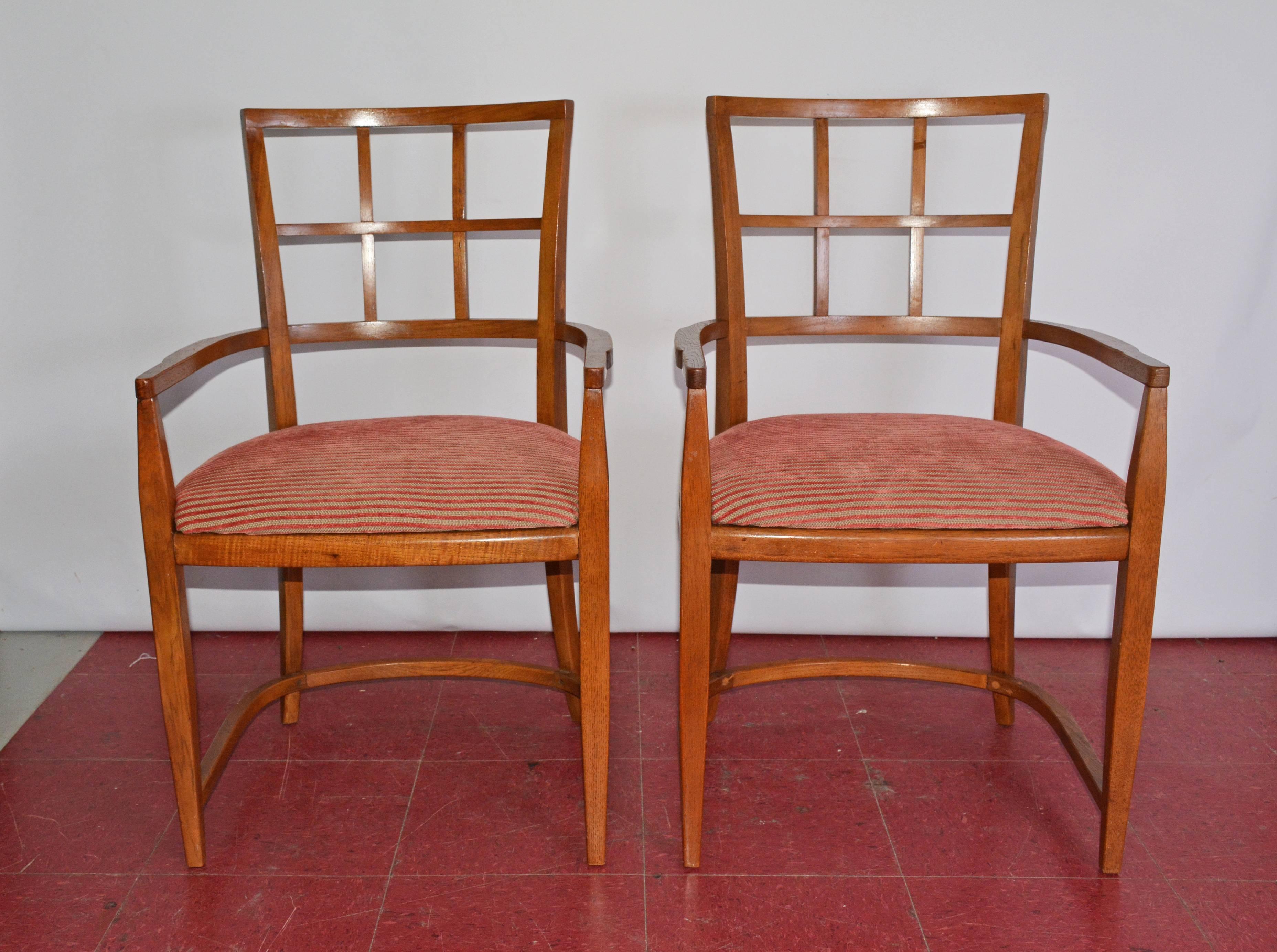 The pair of Art Deco/Mid-Century Modern dining arm chairs have rounded leg framing and backs. The seats are newly upholstered in ribbed red and tan striping. Also be great as office chairs, desk chairs, waiting room chairs or occasional