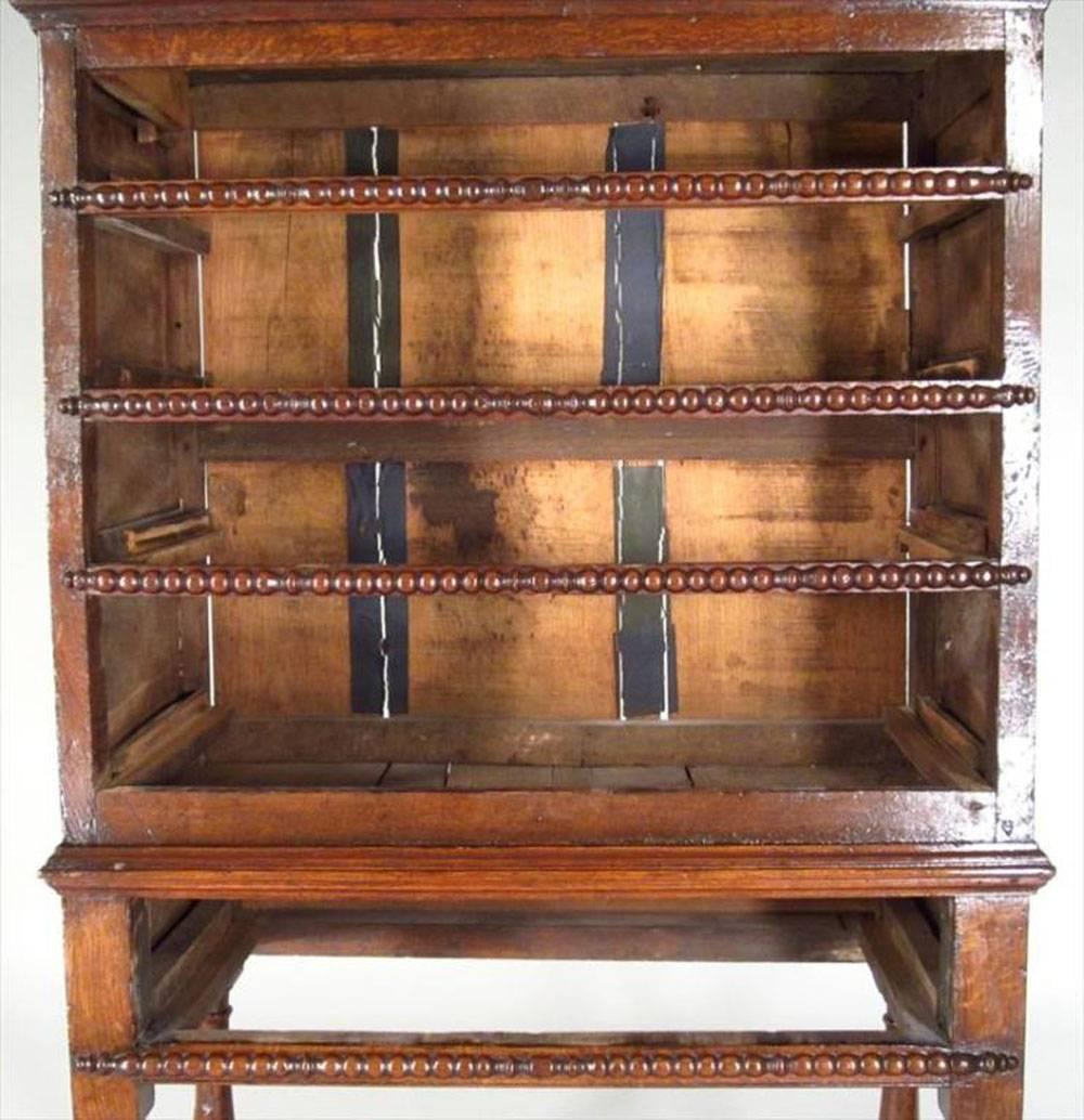 English Jacobean oak chest on later stand, chest fitted with four graduated drawers, on stand with baluster supports with block stretchers.