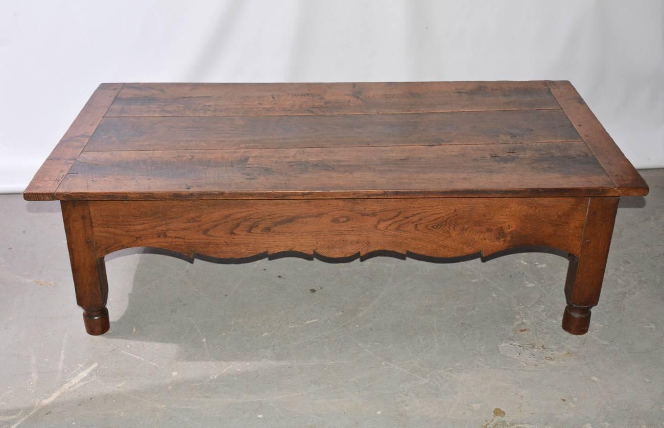 1830s rustic French country Directoire style coffee table is from Provence. Once a worktable for bread making, now with legs cut down and used as coffee table. The rounded dough kneading and rising storage cavity is still under the tabletop.