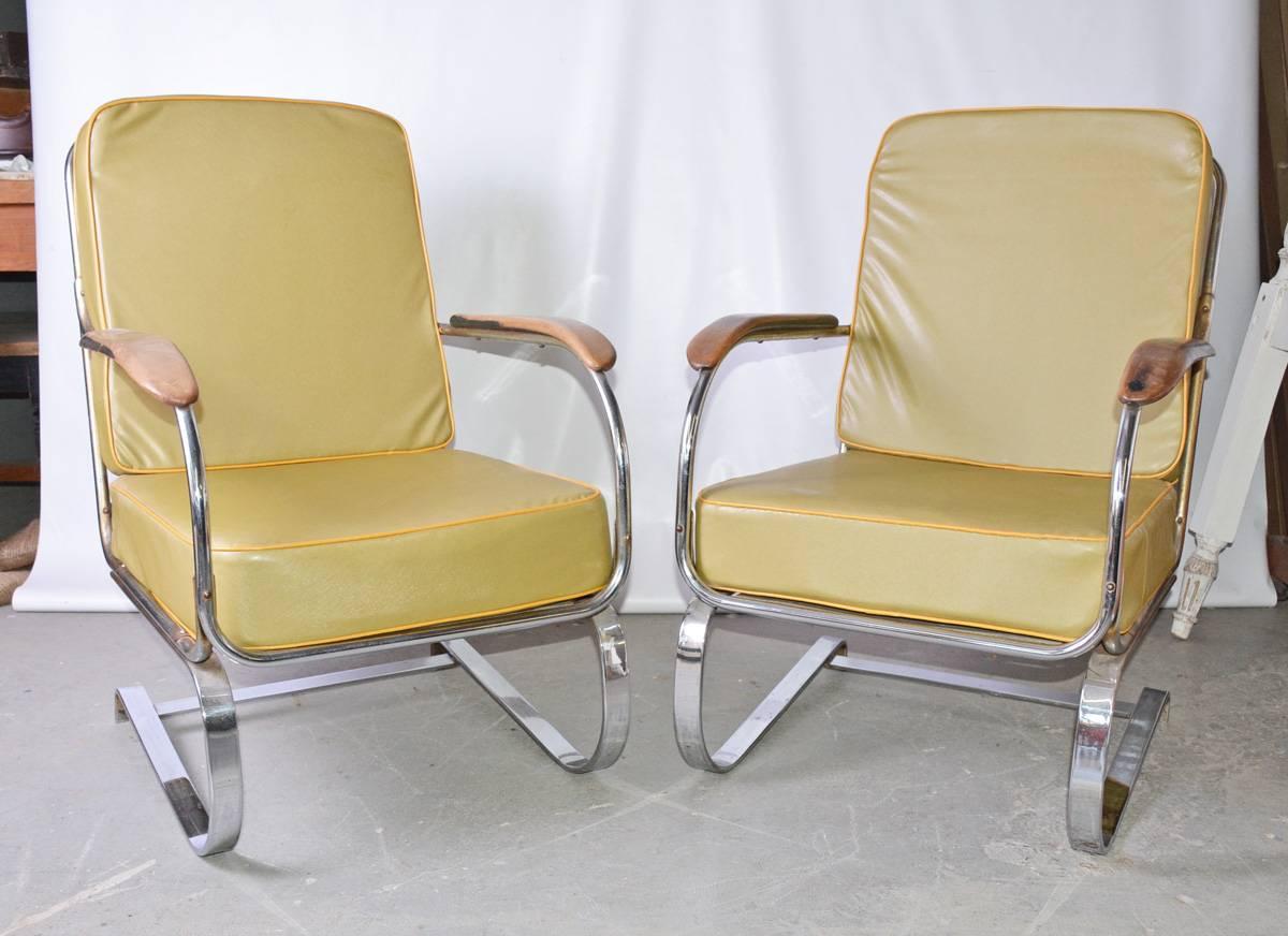 Matching pair of extremely comfortable Machine Age American Art Deco armchairs designed, circa 1935, for Lloyd manufacturing by Karl Emmanuel Martin (KEM) Weber (1889 -1963). Known as the “Springer” chair, the chairs sit on flat band chrome steel