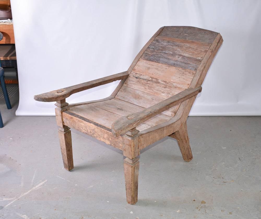 Indoor or outdoor British Colonial teak plantation or planters chair with plank seat and back. Wonderful weathered wood patina.