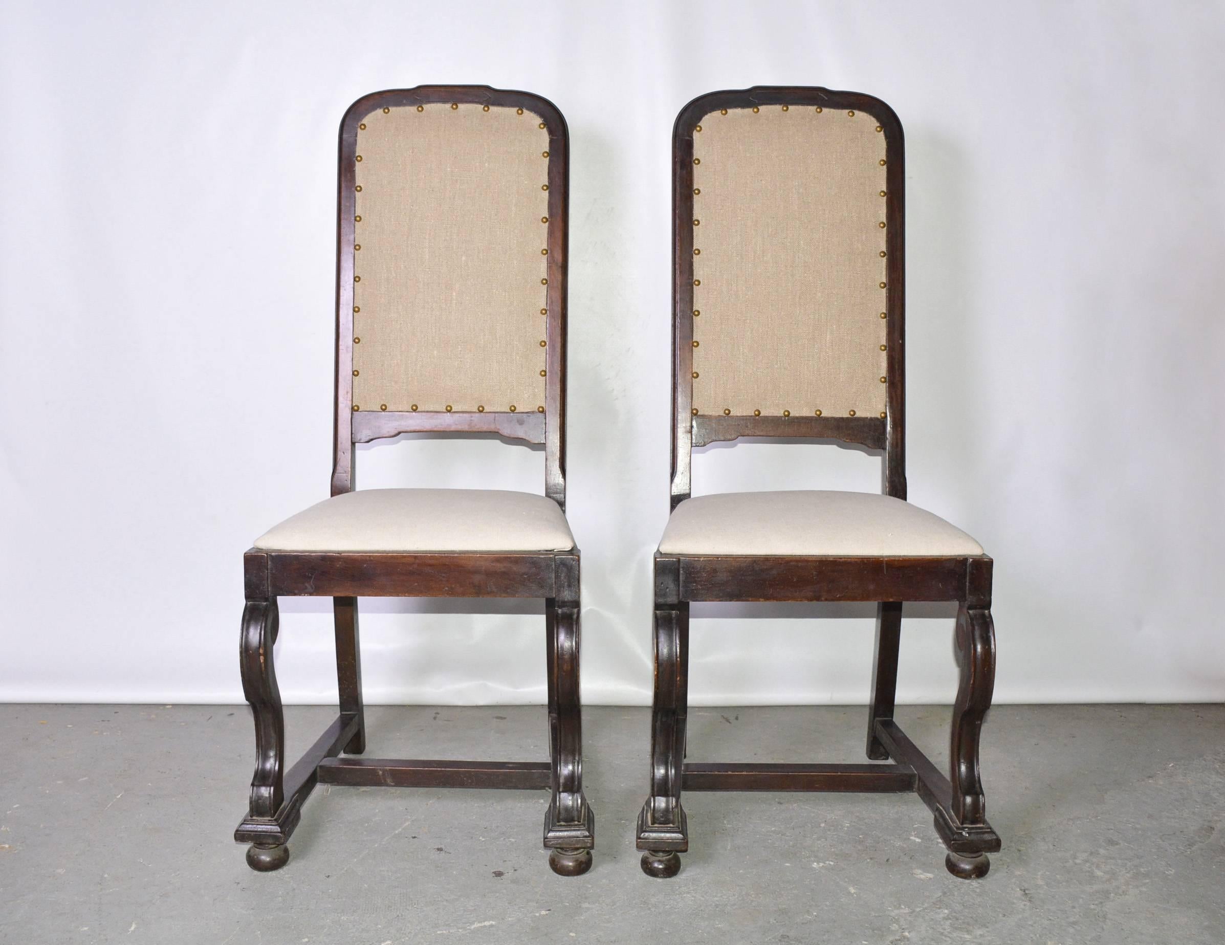 The pair of antique Jacobean-style mahogany side chairs, c.1900, are newly upholstered in one shade of beige linen while the seats are covered in another complementary shade of beige linen. Consider them for the hall or as occasional chairs in the