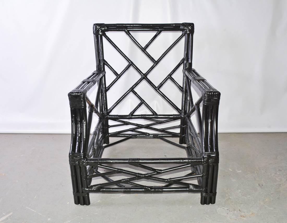 The porch or patio arm chair is made of bound bamboo newly painted glossy black. The pattern of the bamboo reflects trellis work. Ready for comfortable seat and back cushions of your choice. Rattan armchair. Very striking with bold colored or single