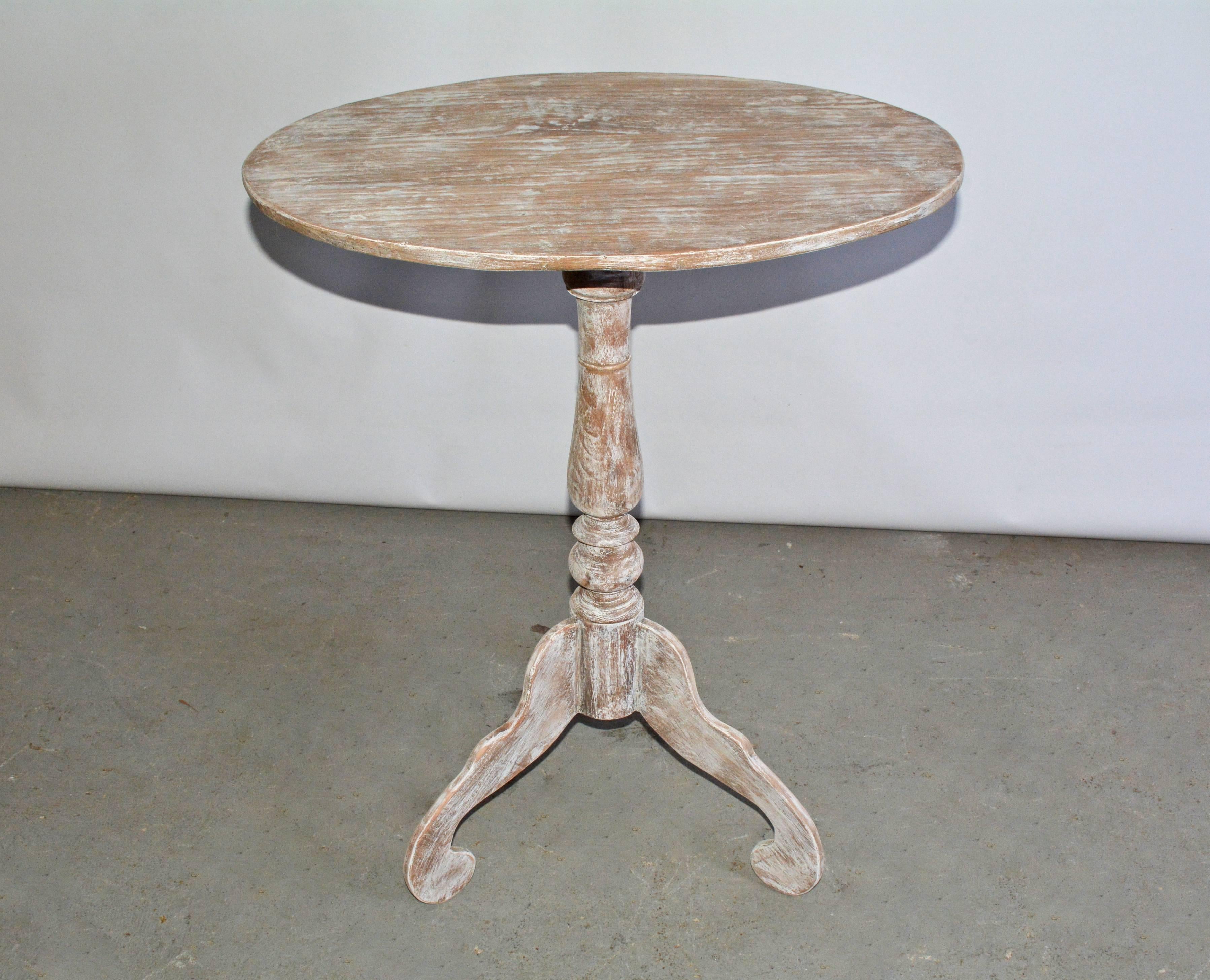 Pair of oval Gustavian or Swedish style teak pedestal tables. Rustic white washed with handcrafted turned base and beautifully carved legs. Perfect as night table, end table, occasional table, tea or wine table. Can be sold singly.