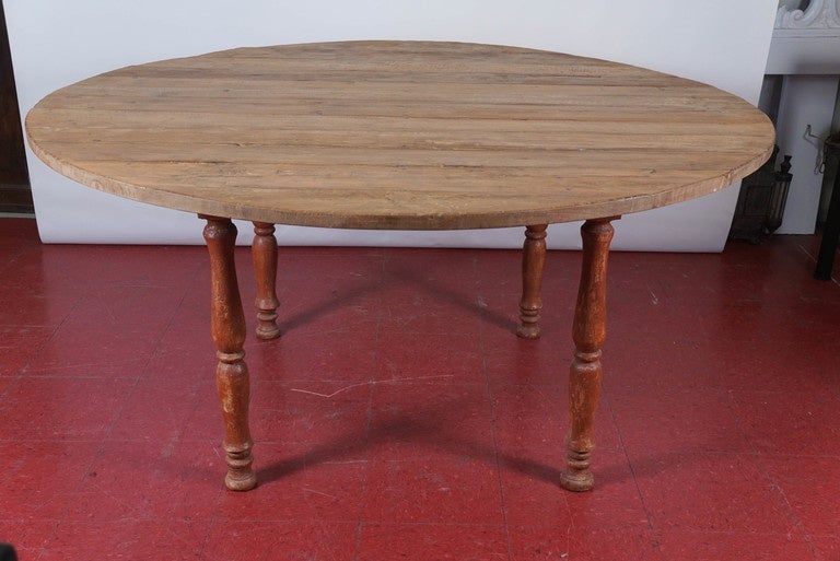The top is waxed teak wood while the red-painted legs attached at the top to a square frame have a pair of flanges that give added support to the top,

Frame: 32.50