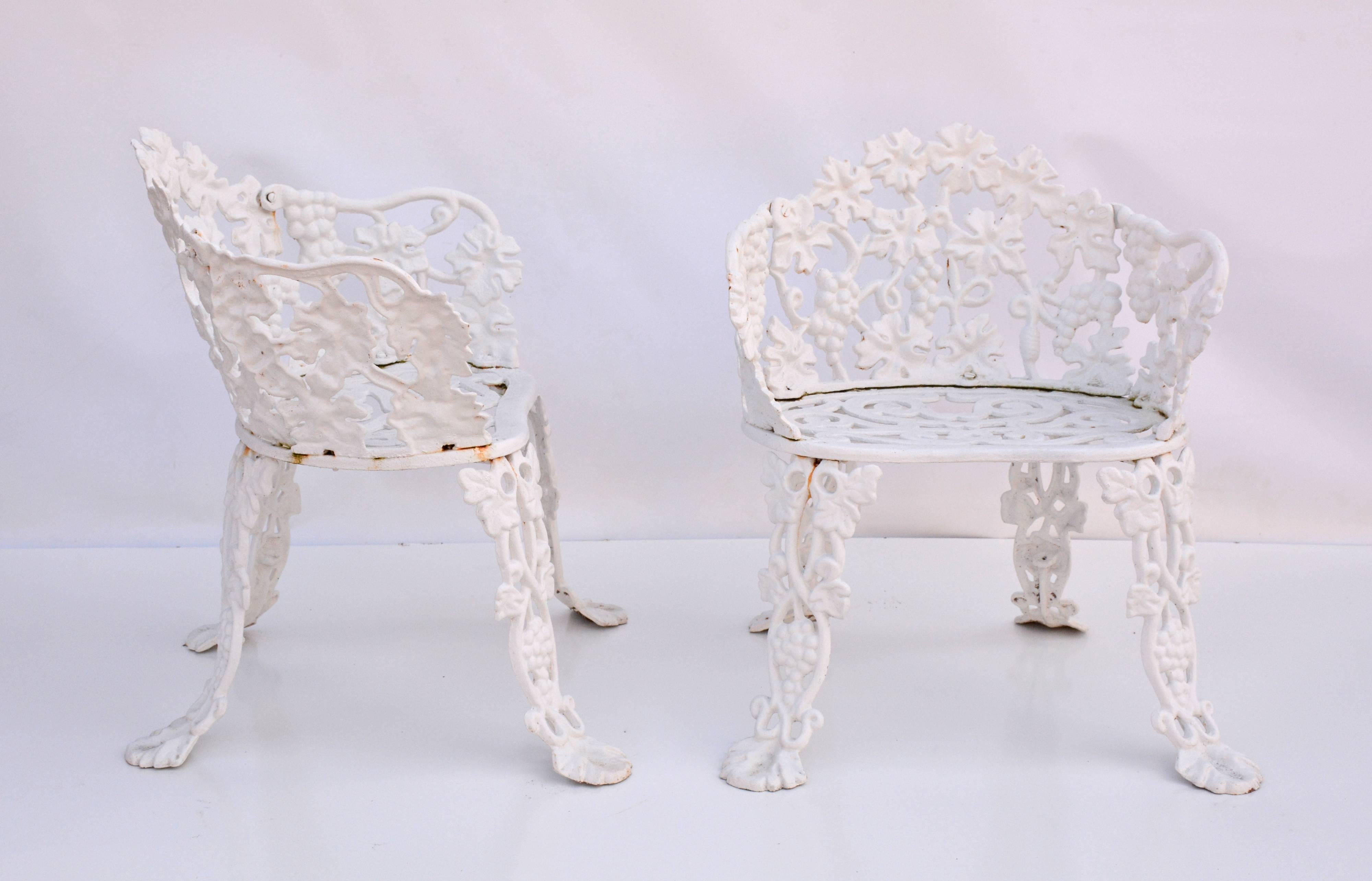 The chairs, painted white, are embellished with grapes, leaves and vines.

Arms: 22.50" H.