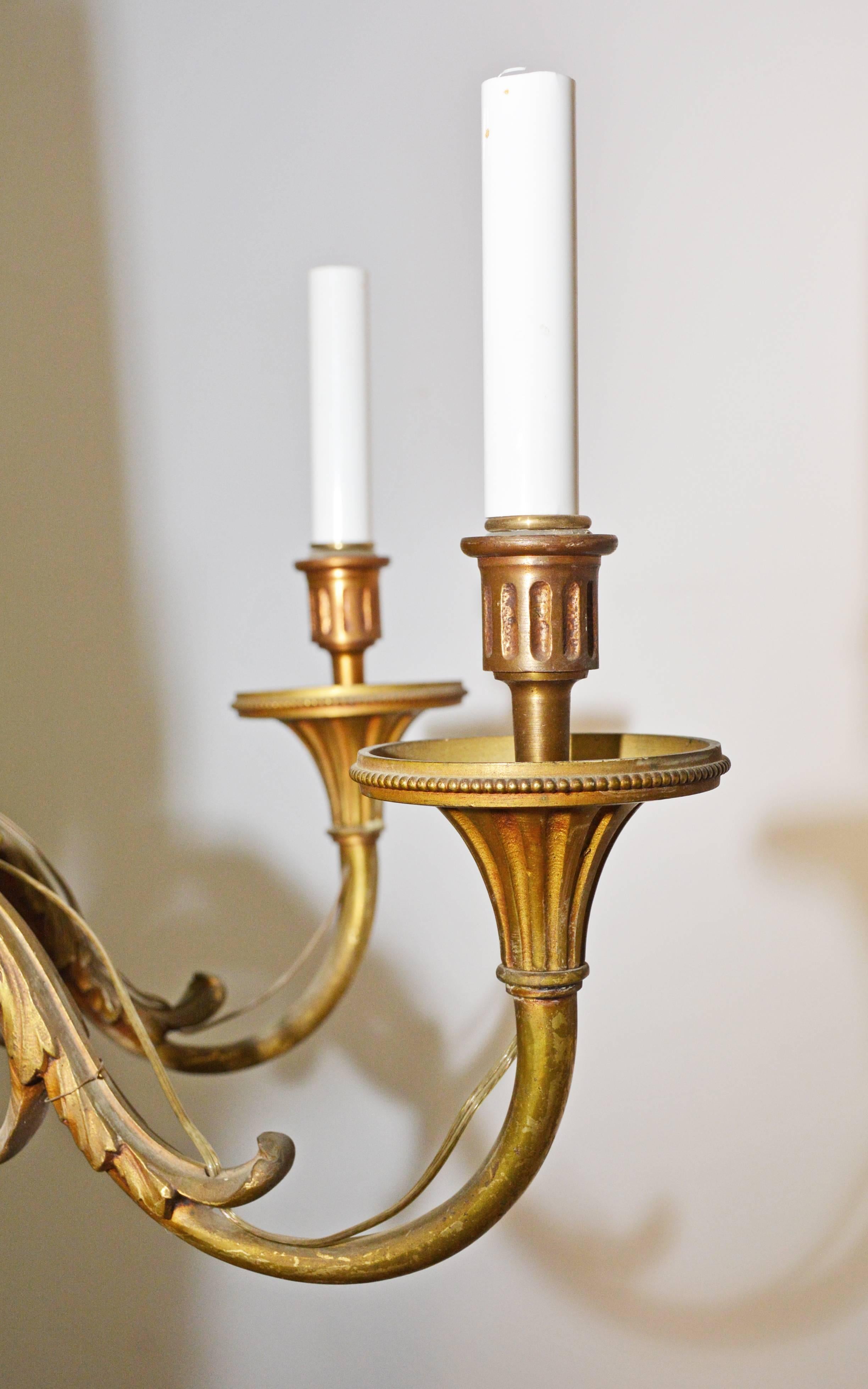 Gilt bronze, 19th century chandelier is in the style of French Louis XVI design. The six branches with leaves undulating along the arms are attached to a tapered and fluted quiver with the feathered ends of the arrows seen at the top.

Search