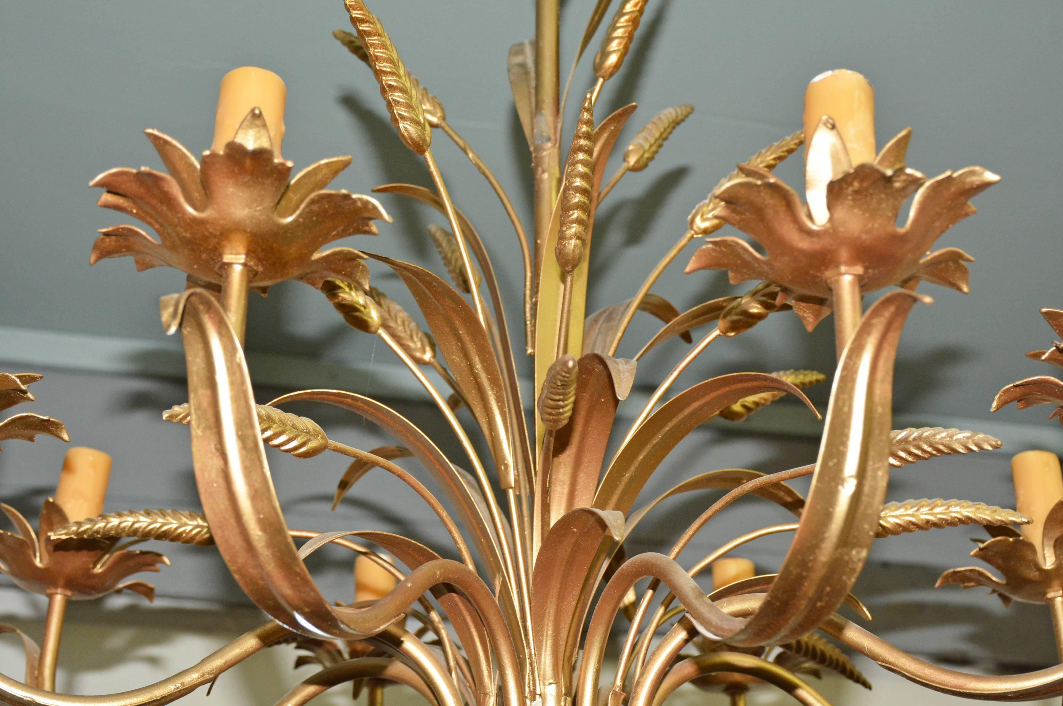 Classic gold gilt sheaf of wheat design eight-light chandelier takes on a country air with its embellishments of blades of grass and plumes. The light armatures and decoration are bound at the bottom by gilt metal twine. The light bobeches are