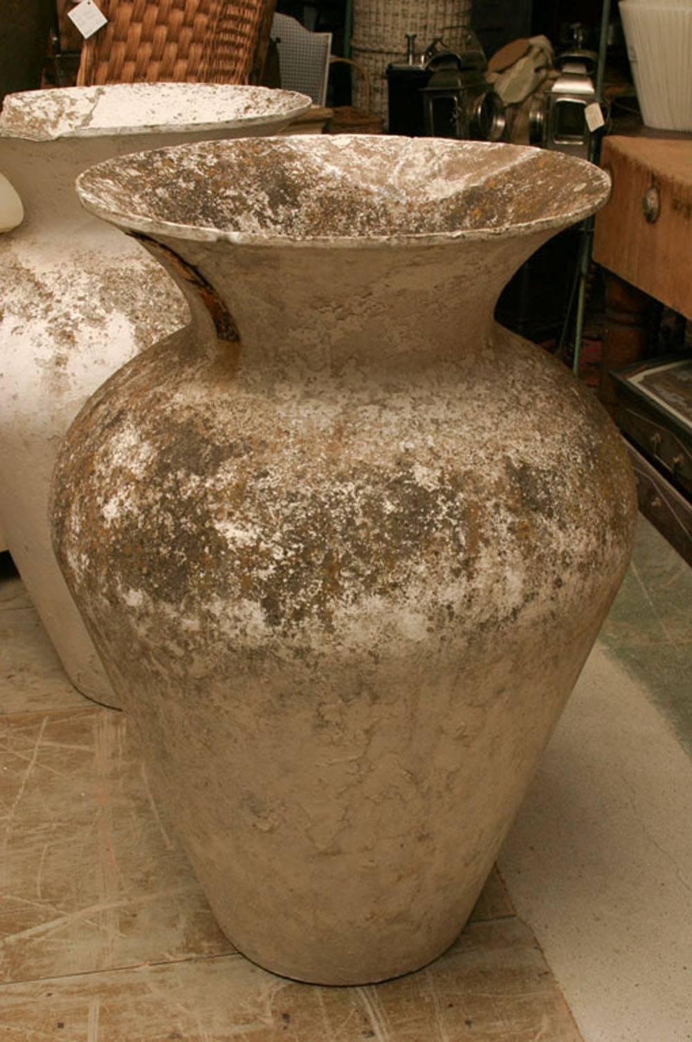 Pair of highly decorative French Urns. Although one shows obvious damage, the urns still have extraordinary presence with aged patina and character.

  