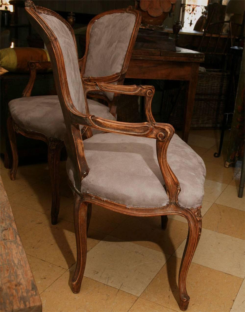 Pair of well-proportioned French armchairs, carved wood and covered in grey ultra-suede.
Measures:
 Arm height: 26