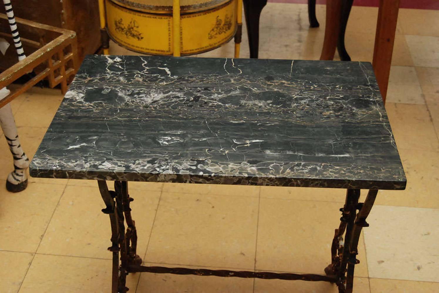 Italian Renaissance style wrought iron end table with lyre style metal base and marble top.