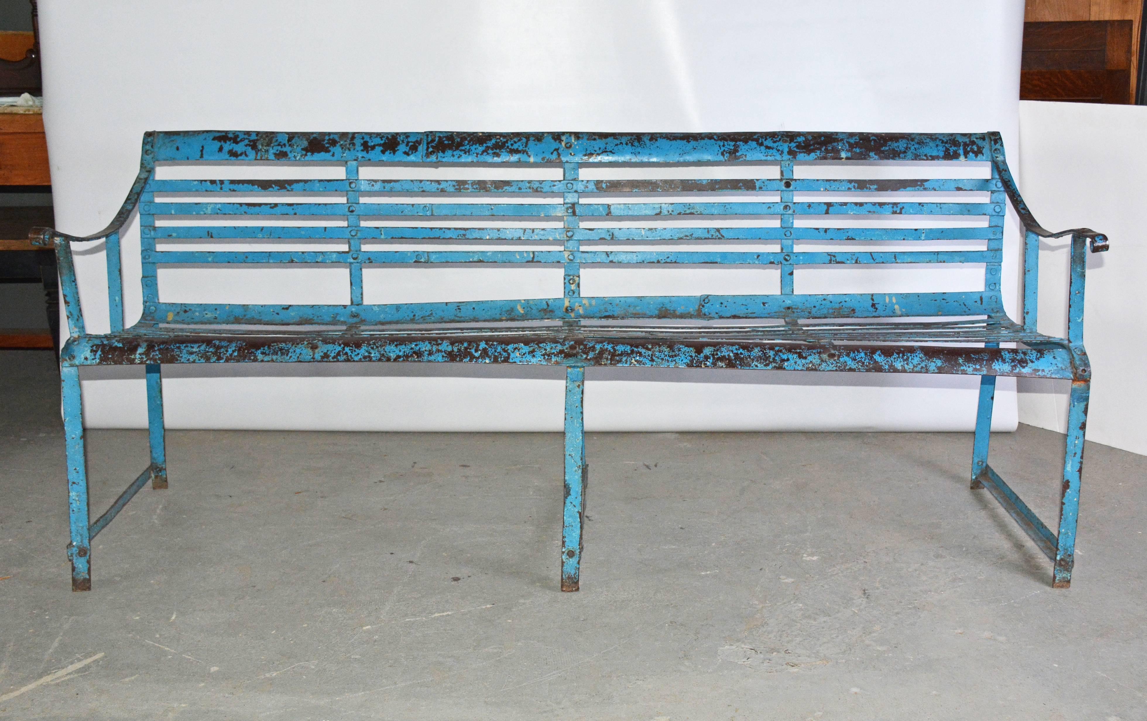 The antique slatted iron bench has a concave seat for comfort. The color is blue-green.

Measures: Seat height: 17